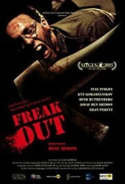 Poster for the horror film 'Freak Out' featuring a man with glasses and an intense expression, holding a gun, with the title in red letters.