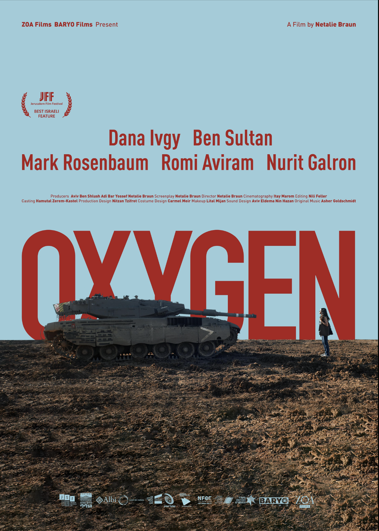 A movie poster for the film 'Oxygen' features a military tank and a woman standing on a barren, rocky landscape with a clear blue sky. The title 'OXYGEN' is prominent in large red letters in the background, with the names of the actors and film credits listed above.