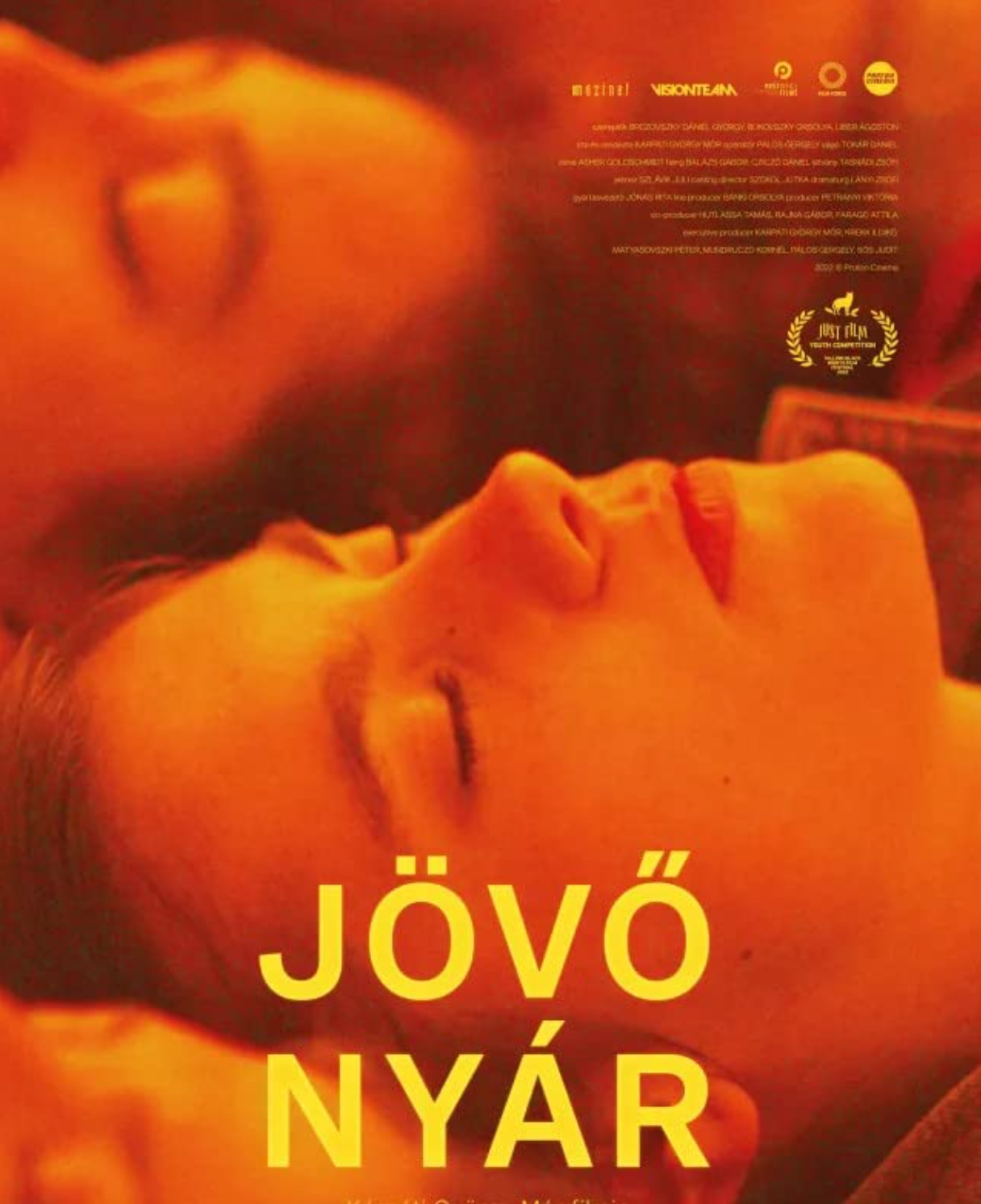 Close-up of a woman with closed eyes and lips parted, illuminated with warm orange lighting, with yellow text reading 'JÖVÖ NYÁR' and awards or film festival logos at the top right.