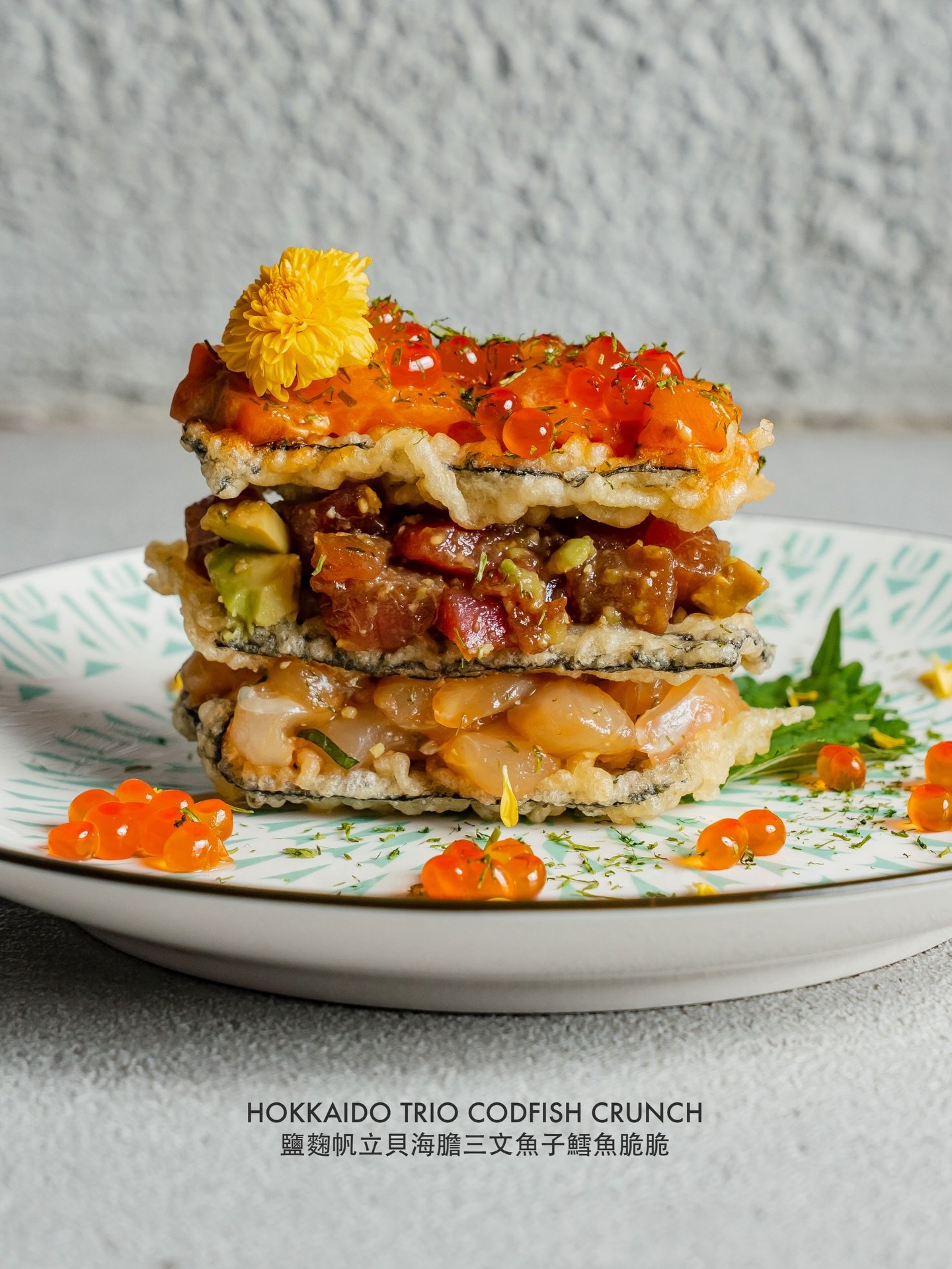 A taste of Hokkaido, crafted with precision. 

The Hokkaido Trio Codfish Crunch brings together delicate scallops, rich uni, and salmon roe in a golden, crisp coating  finished with a touch of shio kōji to deepen the umami.

Each bite honors the puri