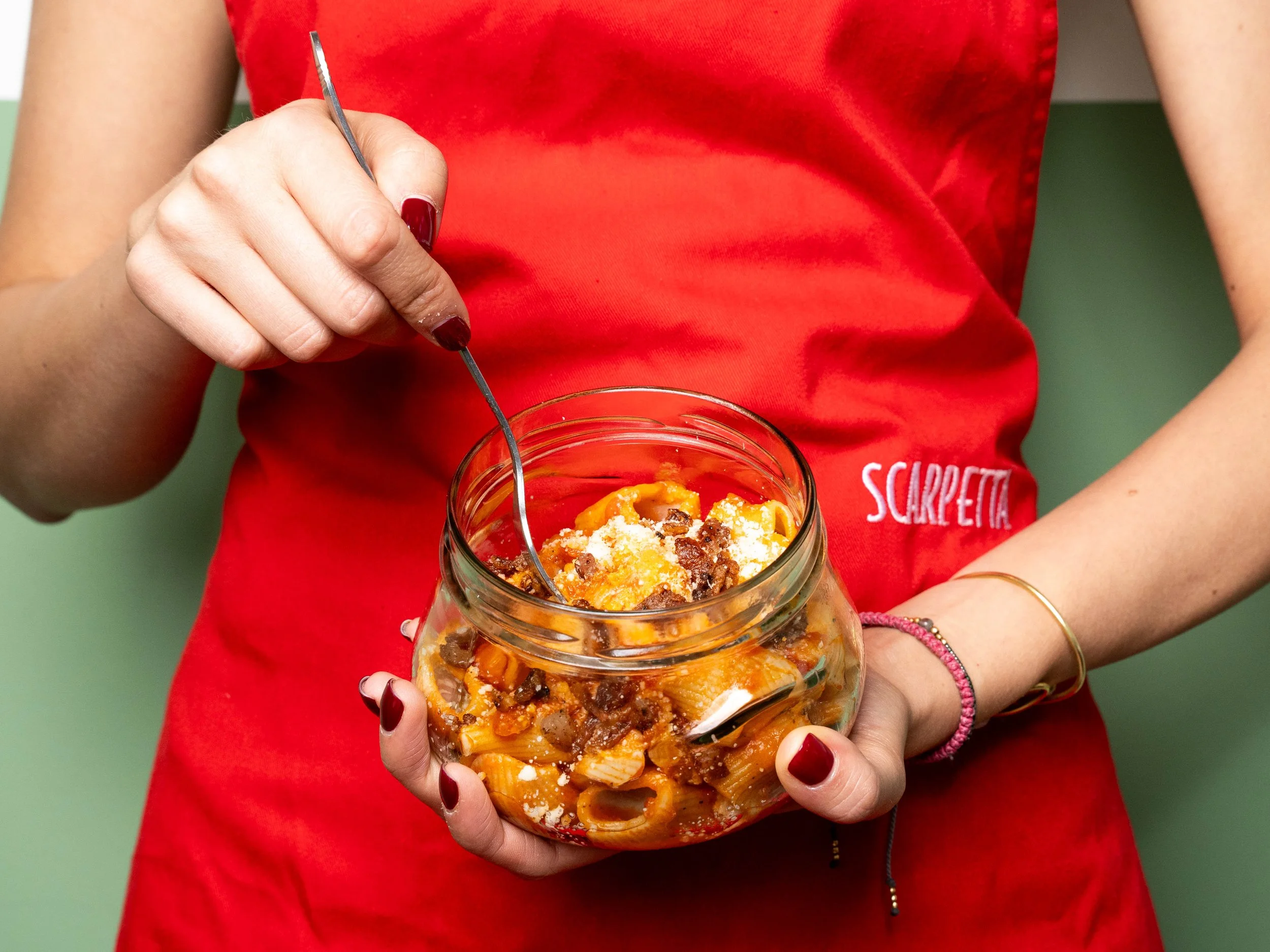 Girl holding a pasta jar