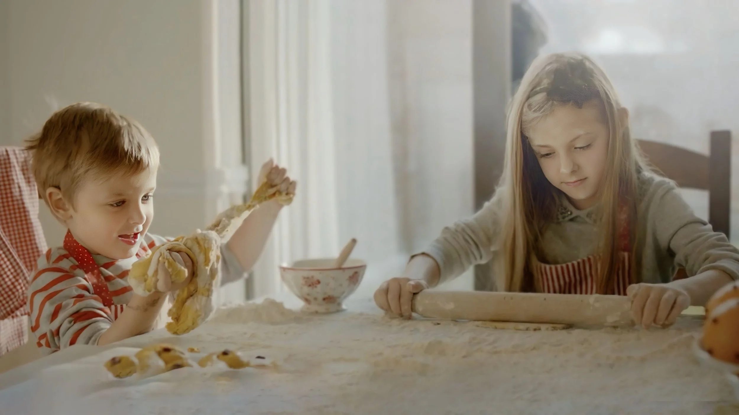 A young boy and girl baking cookies in a kitchen. The boy is tossing dough in the air, while the girl is rolling dough with a rolling pin. Flour is spread on the table.