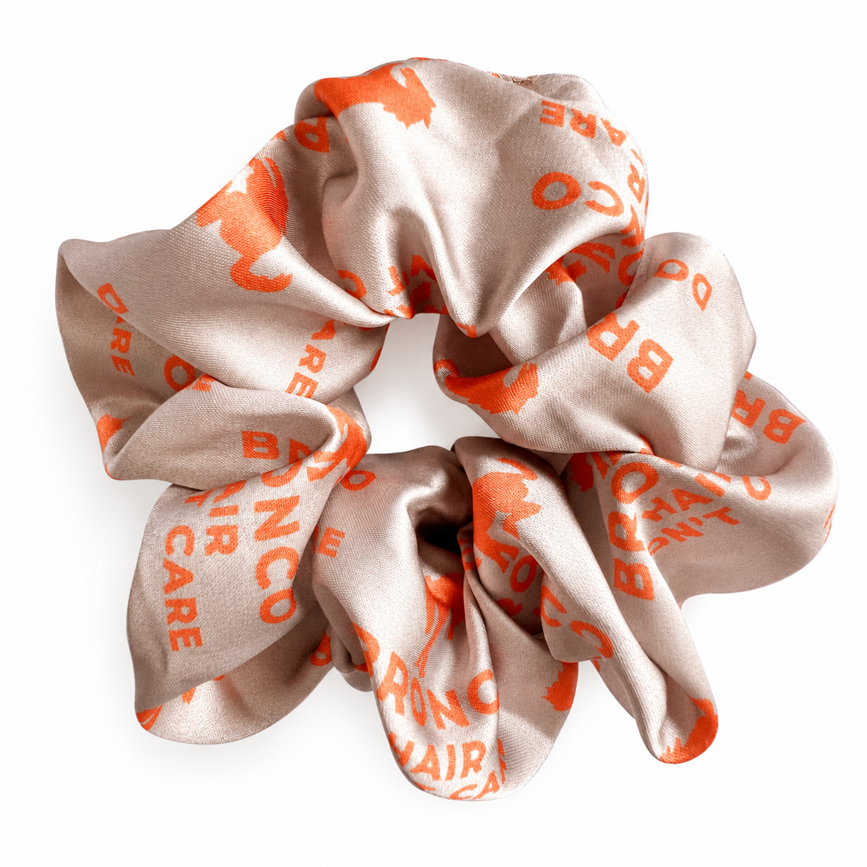 Women's tan satin Bronco Hair Don't Care scrunchie with coral Bronco horse print.
