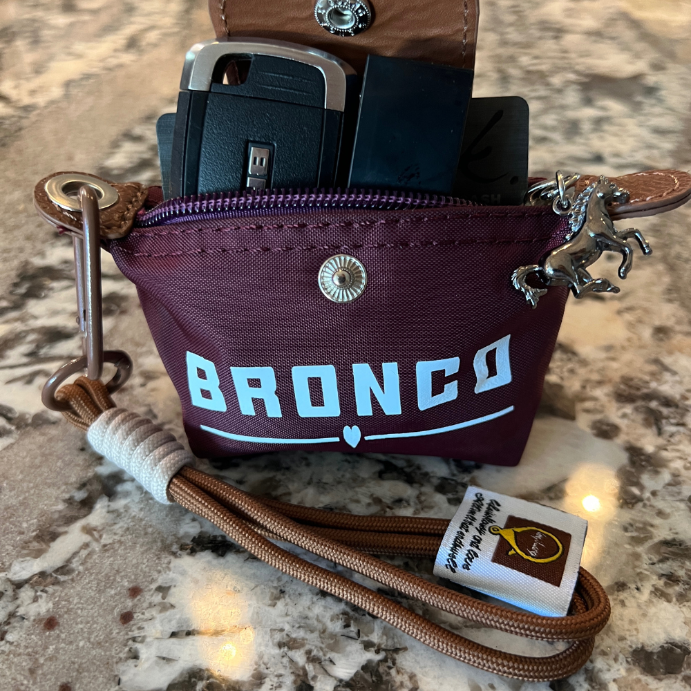 Bronco nylon mini key case in wine holding a Bronco key, lip stick, credit card