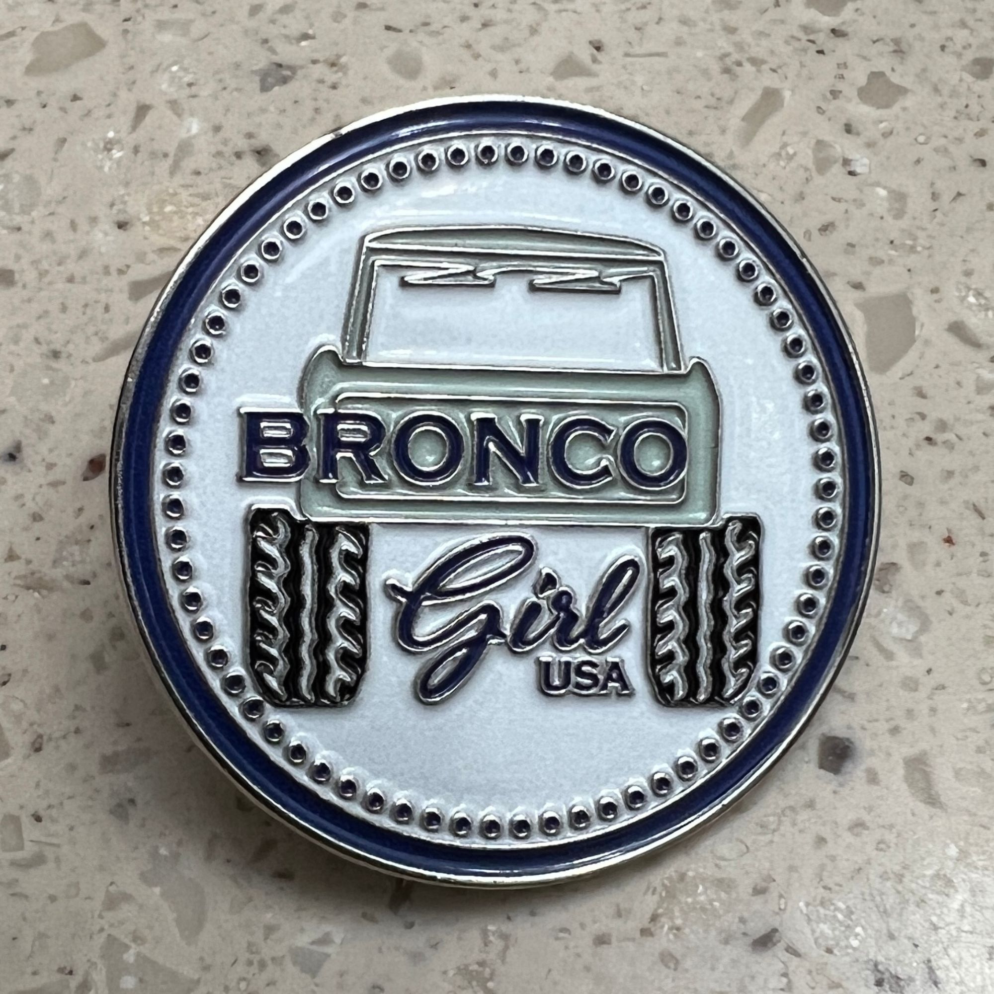 Bronco Girl USA blue soft enamel pin featuring a classic Bronco tailgate design with silver metal finish.
