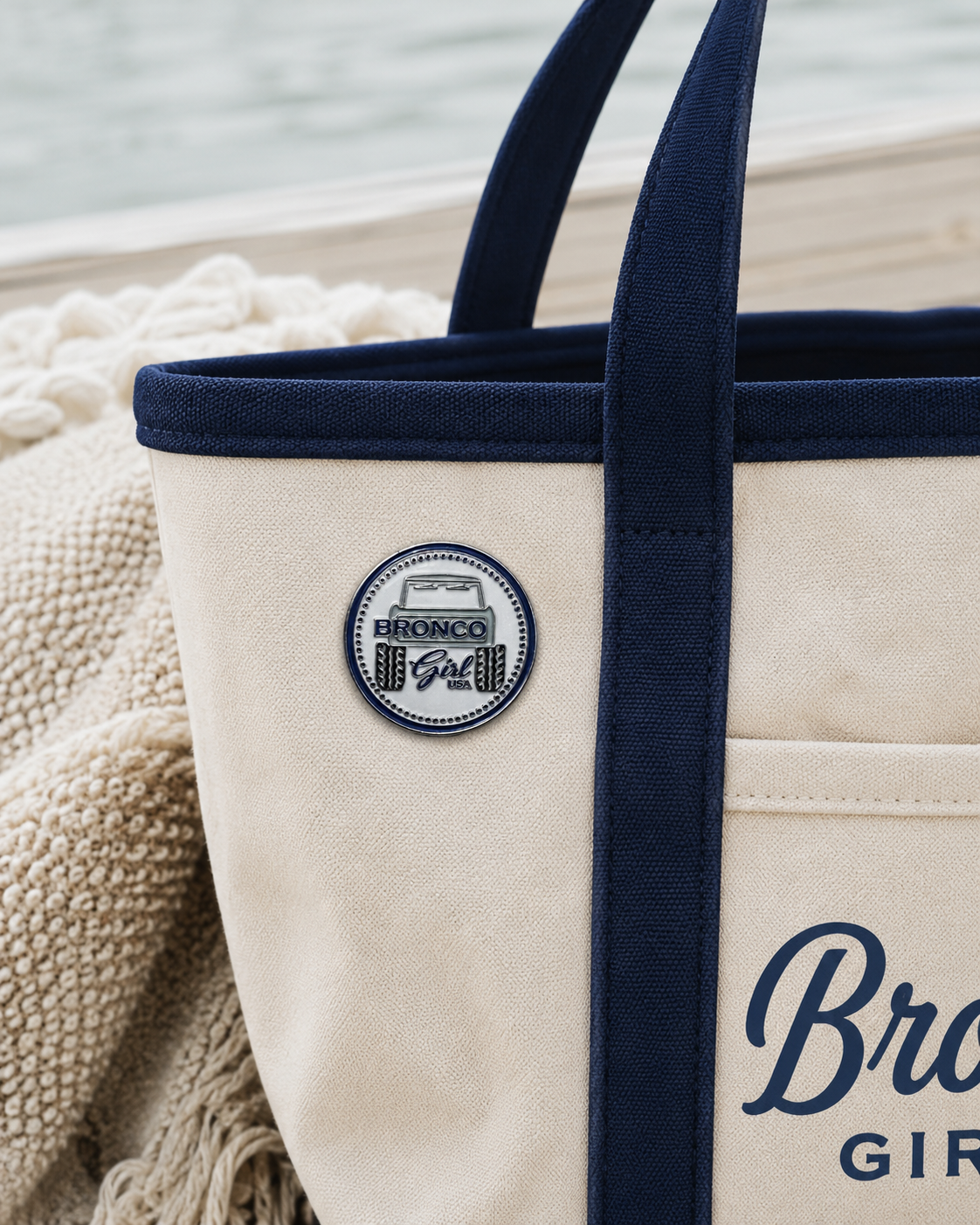 Bronco Girl USA blue soft enamel pin featuring a classic Bronco tailgate design with silver metal finish on tote
