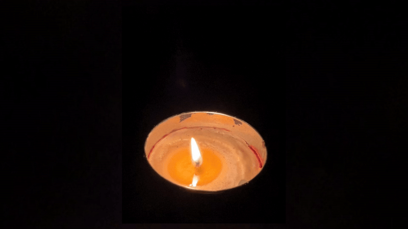 A candle flickering in the darkness