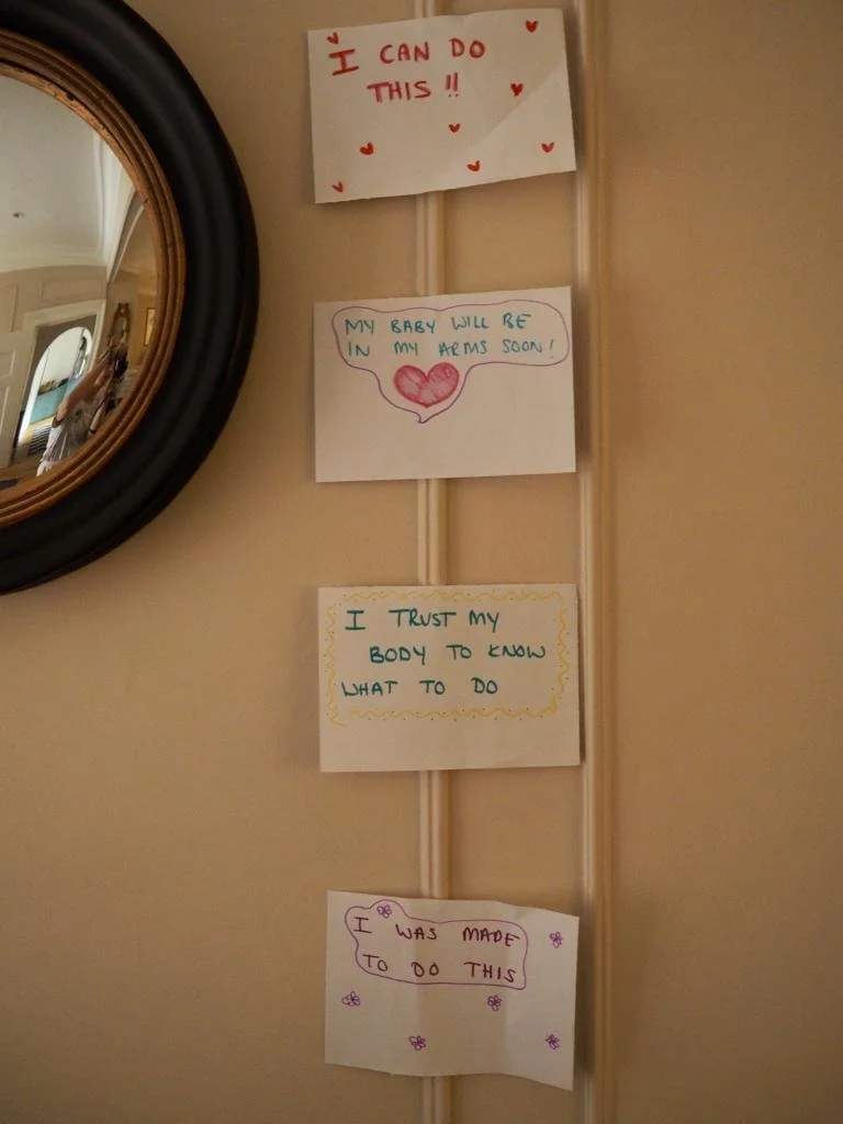 Four handwritten motivational notes taped to a wall, decorated with hearts, a speech bubble, and doodles.