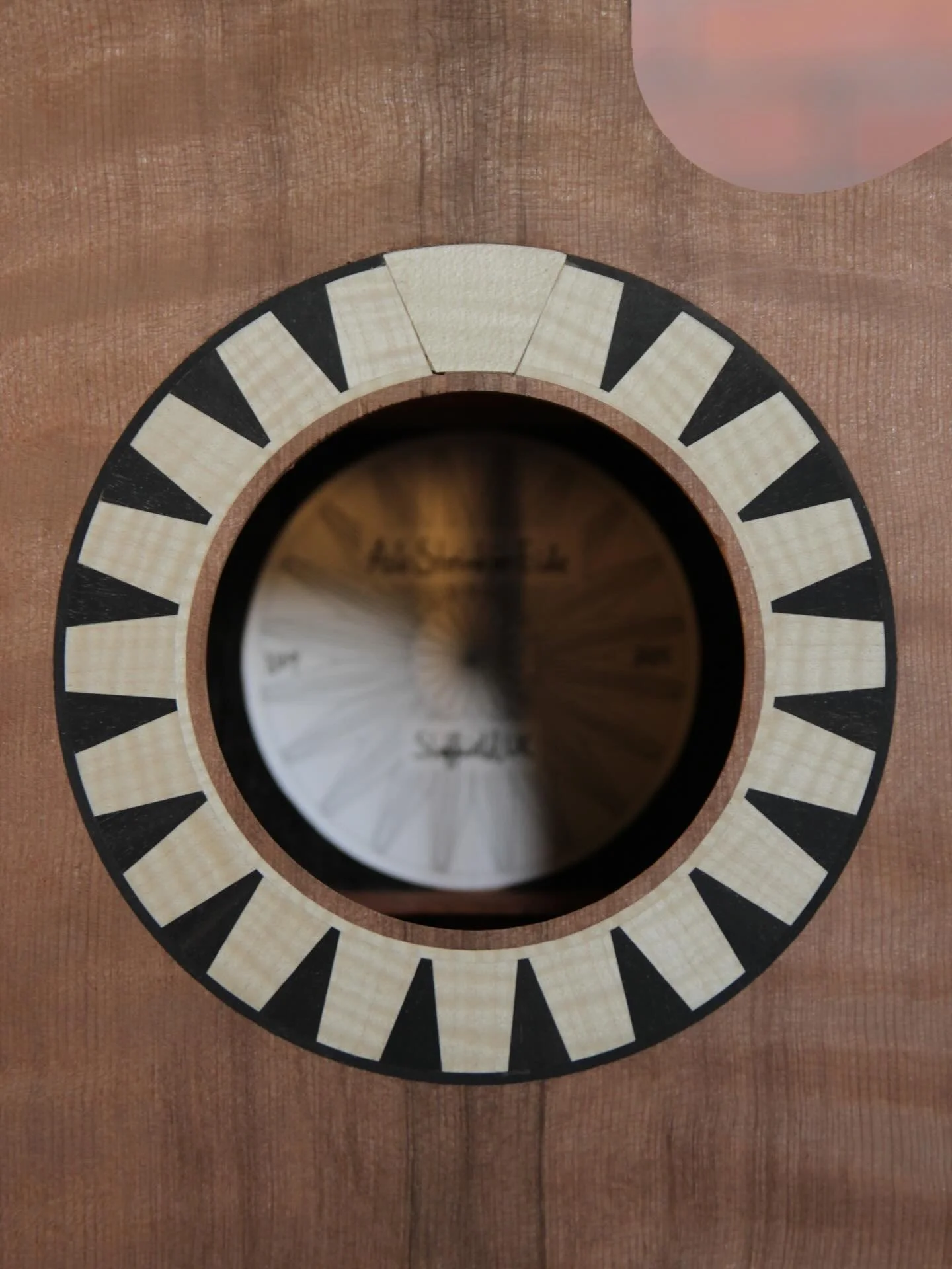 For this redwood topped guitar, my customer wanted a rosette design that meant something special to him. After a lot of back and forth, we landed on a design based on a modern church from his home town on Sicily. To really get the effect of the struc