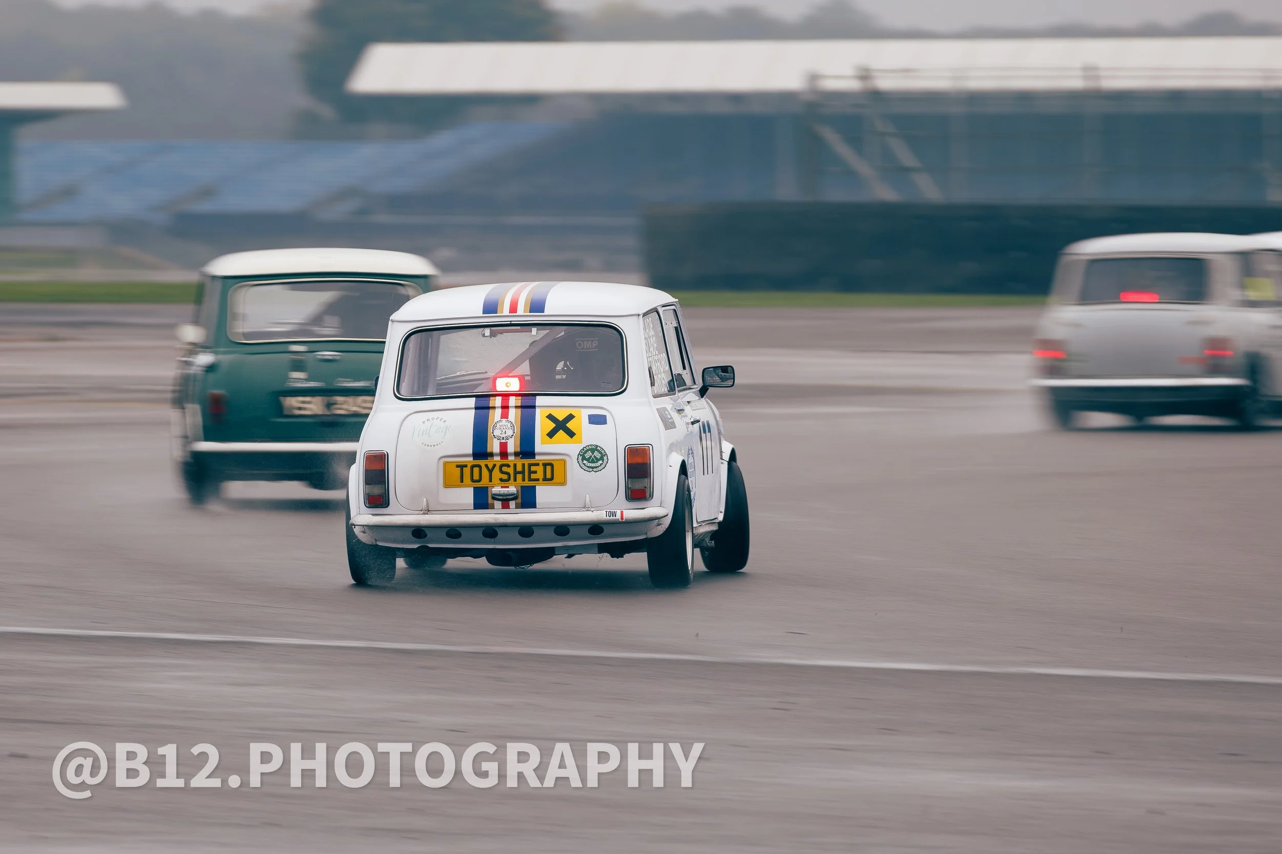 A small vintage race car with a toy-themed design, labeled 'TOYS