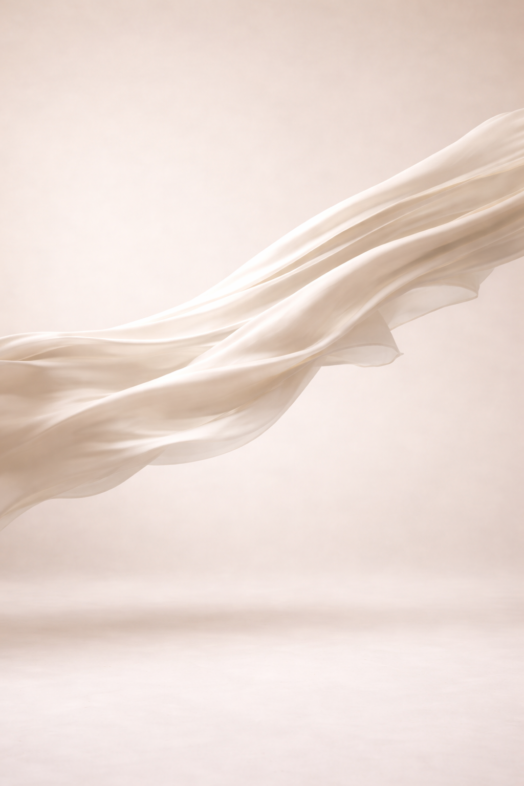 Close-up of flowing white fabric or material with smooth textures and gentle waves.