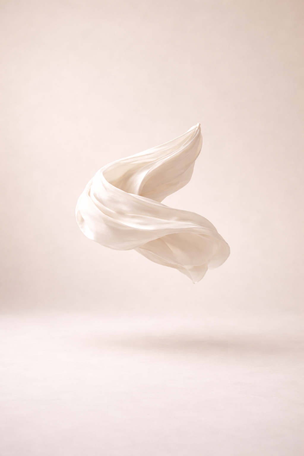 A white fabric or material twisted and floating against a plain beige background.