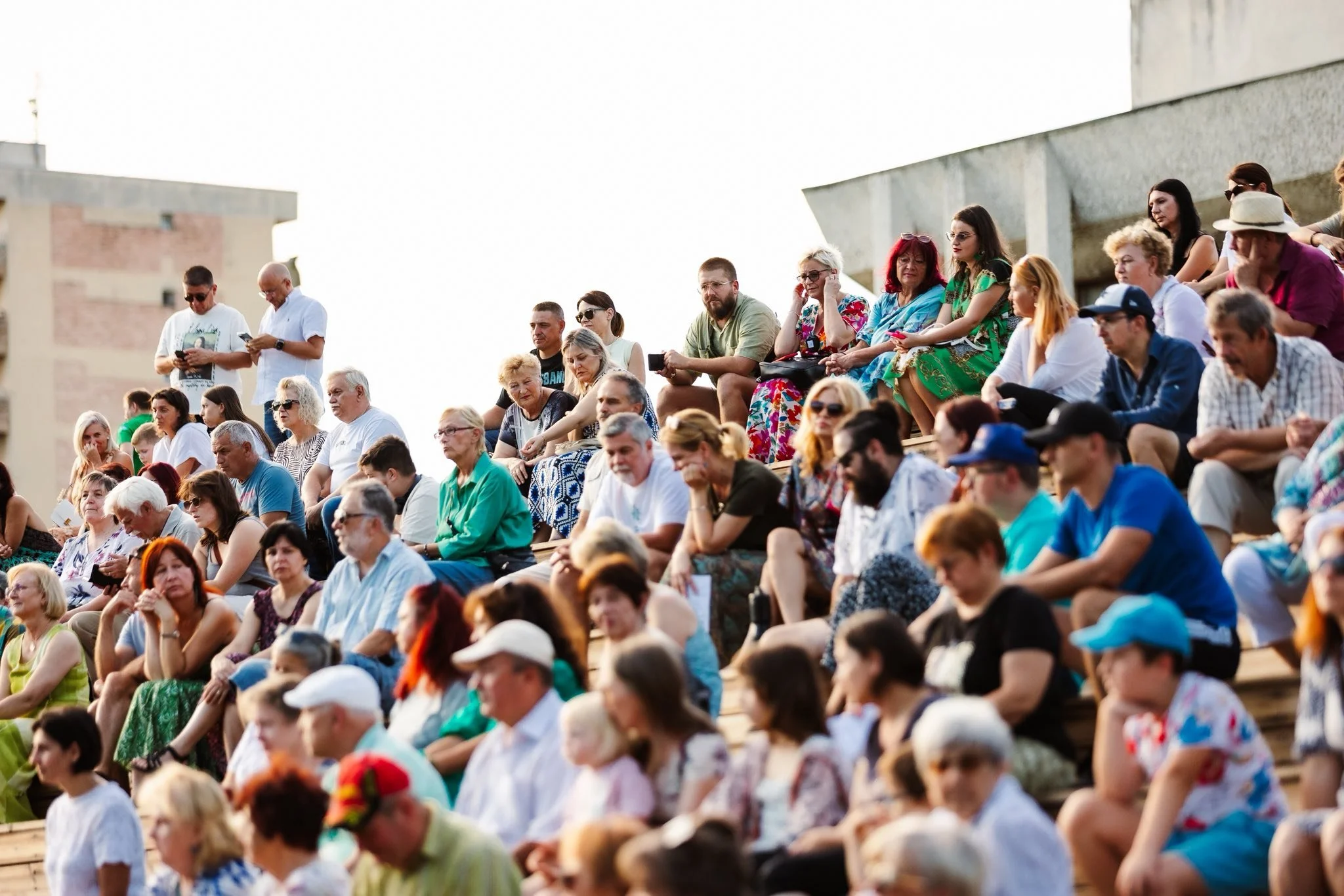 Audience seated on outdoor steps at an event