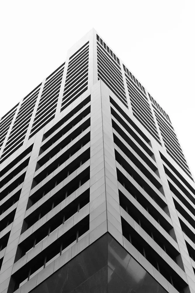 Black and white photo of a tall modern office building in Boston Massachusetts taken from the ground looking up.
