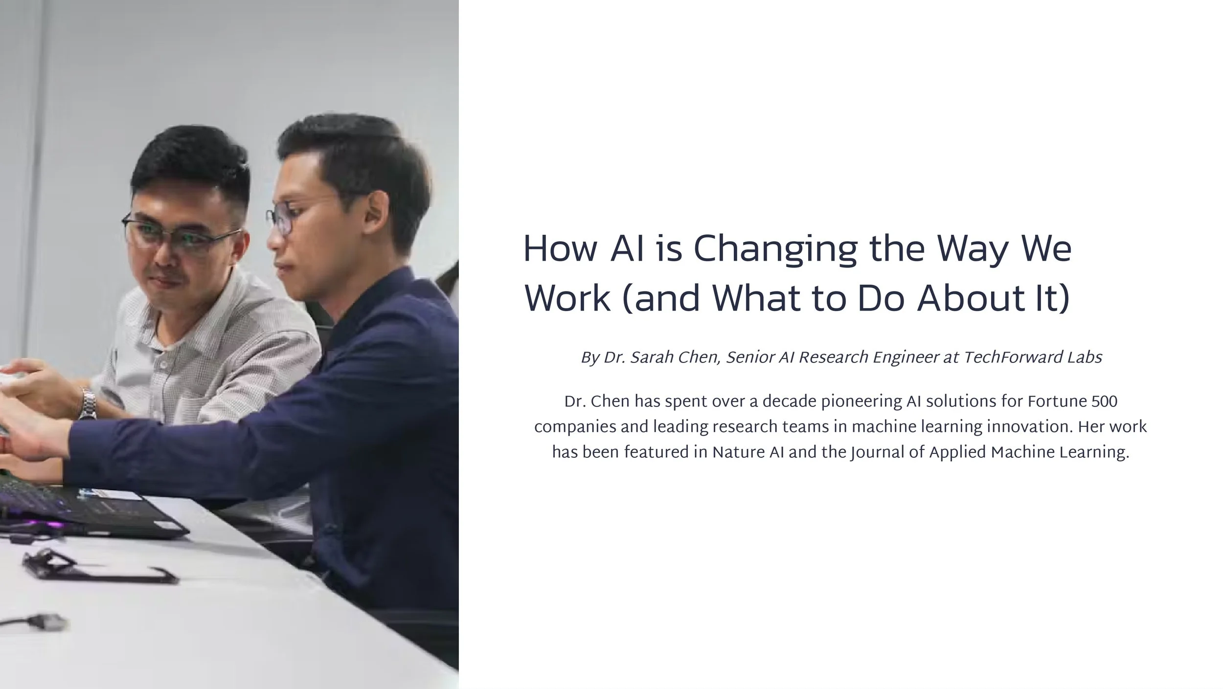 Two men in glasses working together with a computer on a white table, discussing a topic related to AI.