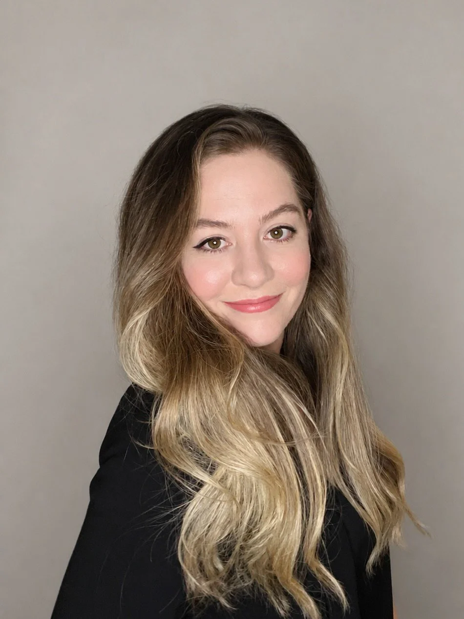 Iliana Romanul, fine art nature photographer, in a professional headshot against a neutral background.