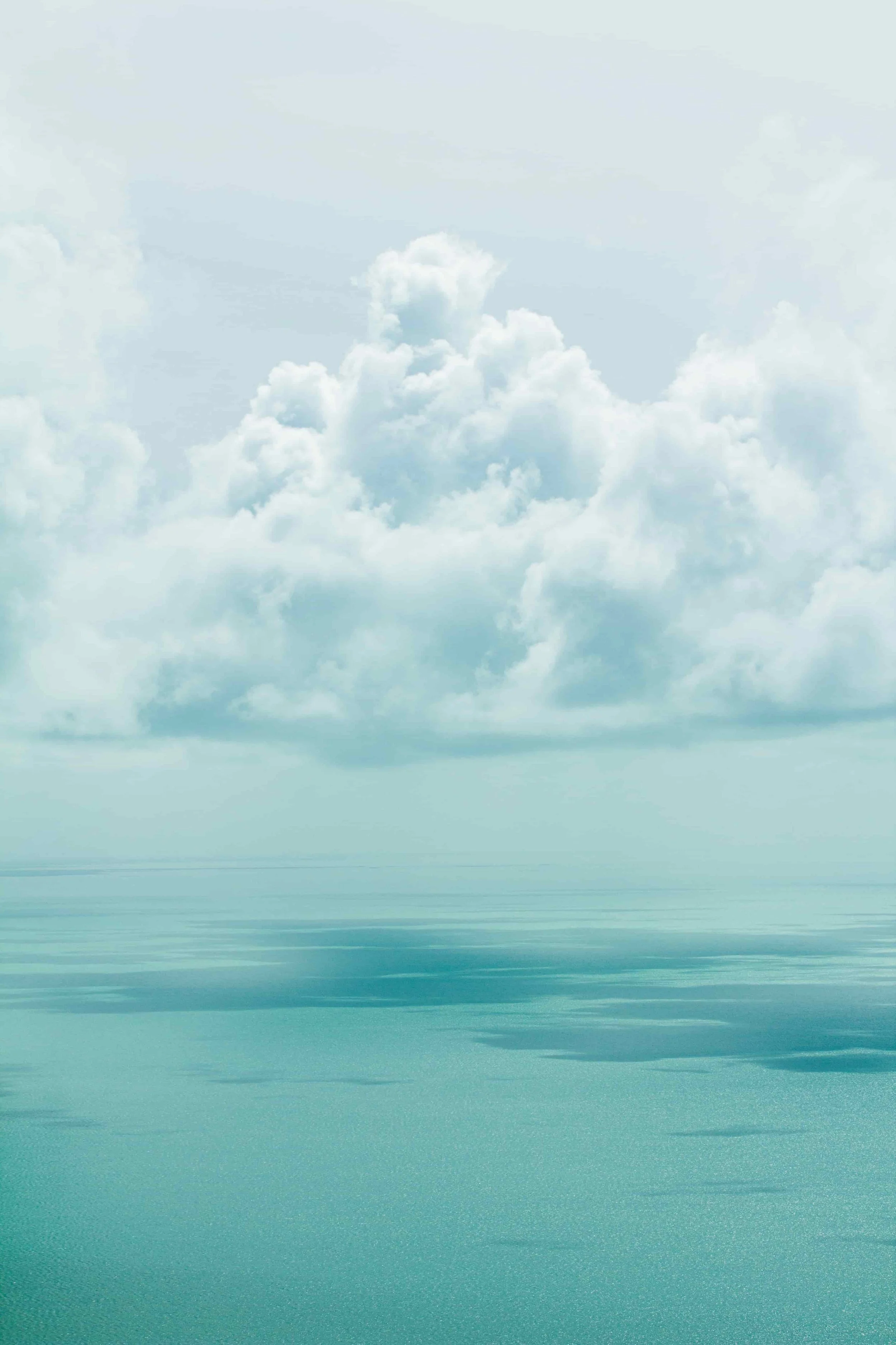 Calm ocean water with a cloudy sky above.