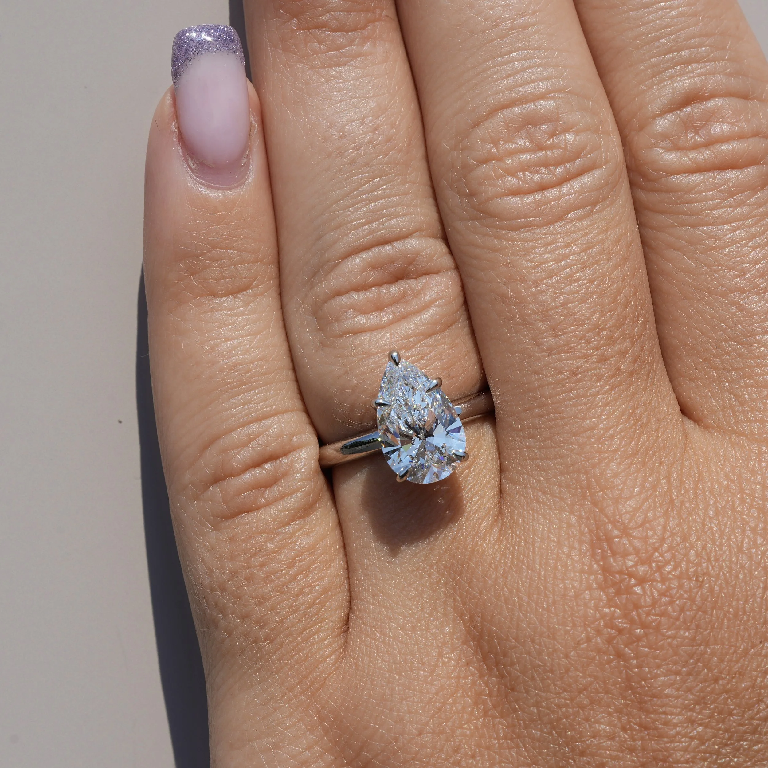 3ct Pear Cut Diamond Hidden Halo Ring in Platinum – IGI Certified – Hand View | Eighty8Diamonds