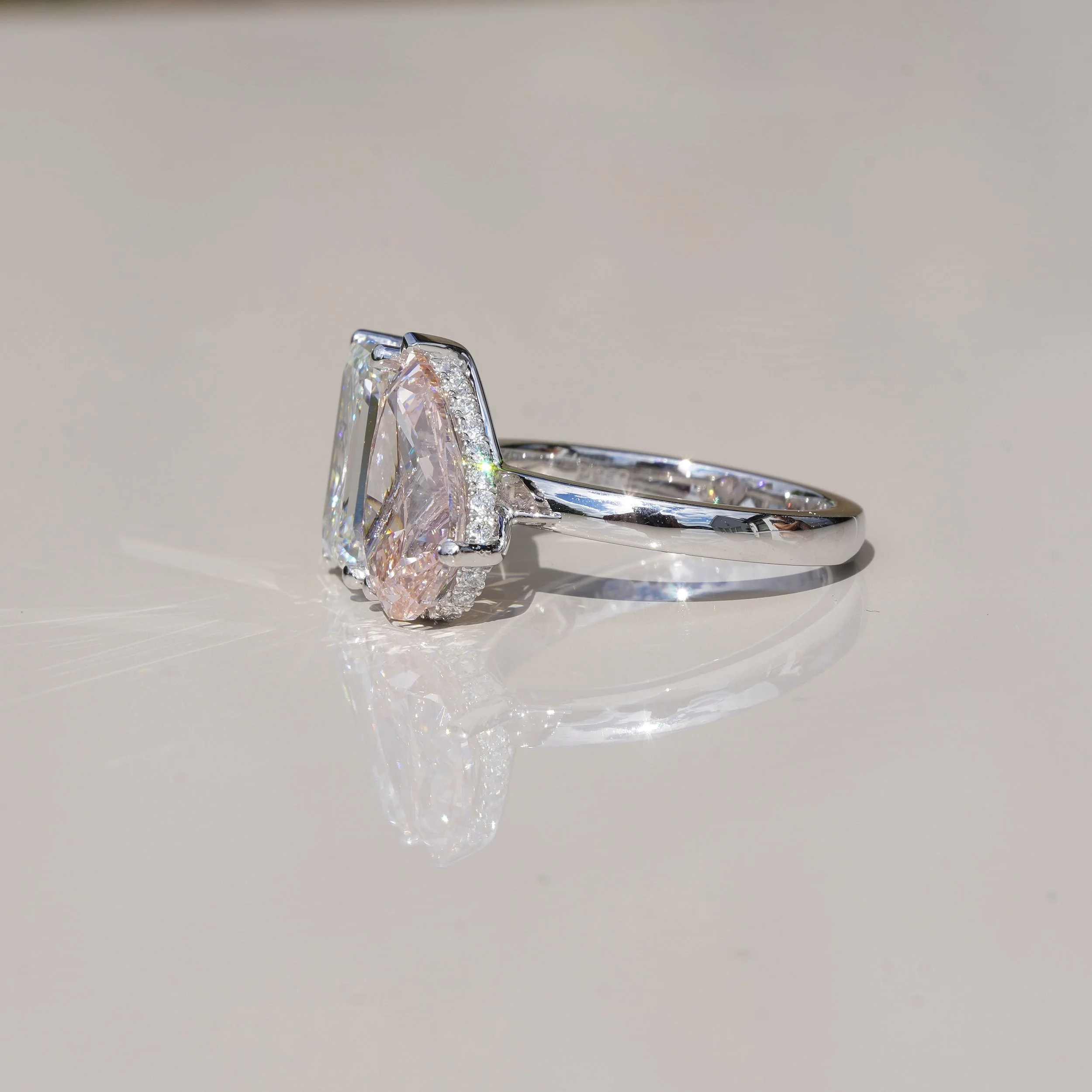 Toi et Moi Ring with 3.5ct Fancy Vivid Pink Pear Cut Diamond and 4.0ct Emerald Cut Diamond with Hidden Halo in Platinum, Total Carat Weight 7.70ct – Side View | Eighty8Diamonds