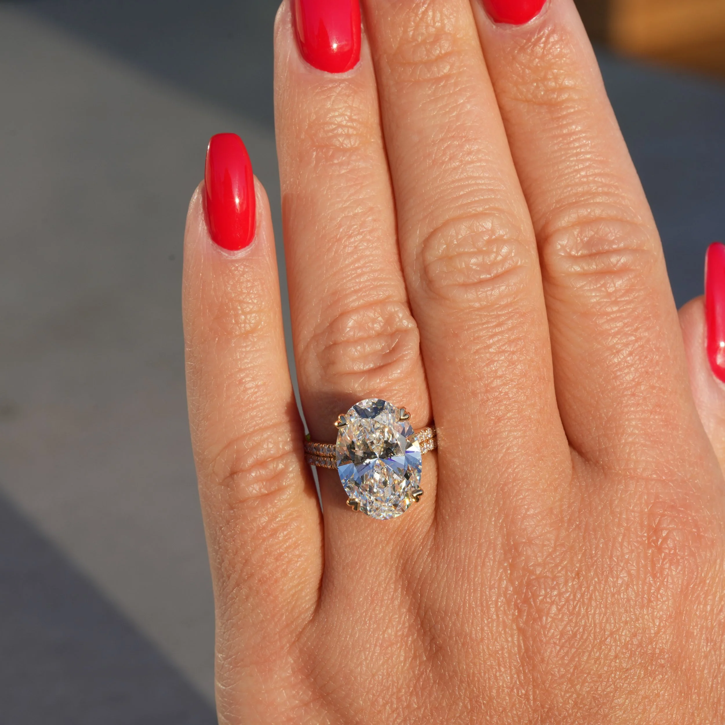 8ct Oval Cut Diamond Engagement Ring with Diamond Band in 18ct Yellow Gold – Hand View | Eighty8Diamonds