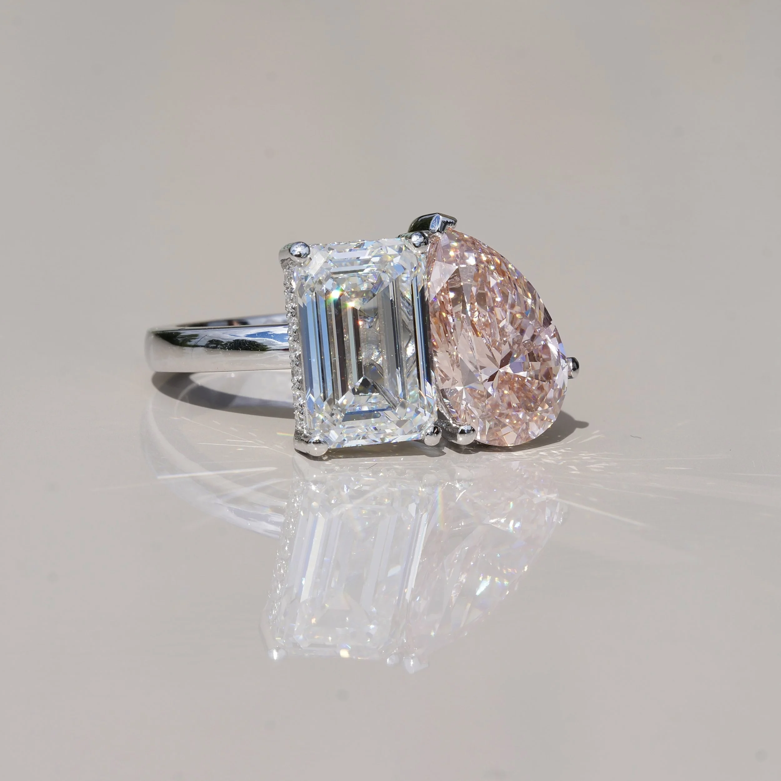 Toi et Moi Ring with 3.5ct Fancy Vivid Pink Pear Cut Diamond and 4.0ct Emerald Cut Diamond with Hidden Halo in Platinum, Total Carat Weight 7.70ct – Angeled View | Eighty8Diamonds