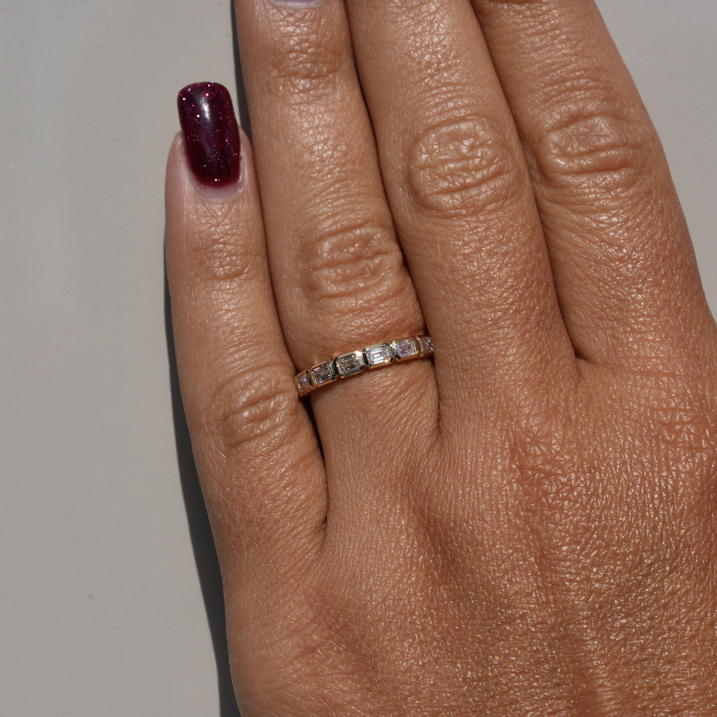 Emerald Cut Diamond Bezel Setting Half Eternity Band | 18K Yellow Goldwith 0.80ct  Diamonds –Hand View | Eighty8Diamonds
