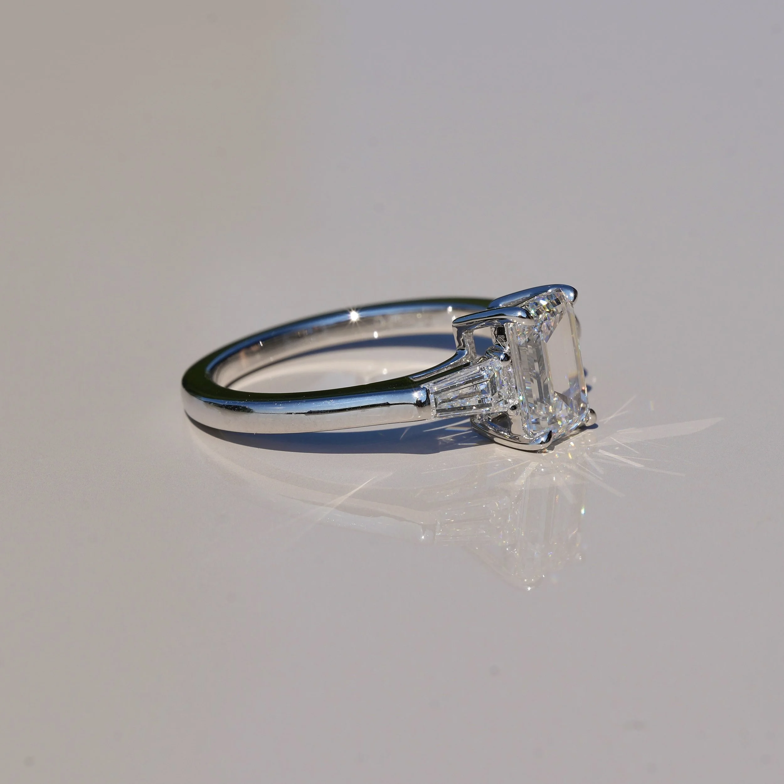 Emerald Cut Trilogy Ring with 1.5ct Centre Stone and Two 0.25ct Baguette Side Stones in 14ct White Gold, Total Carat Weight 2ct – Box View | Eighty8Diamonds