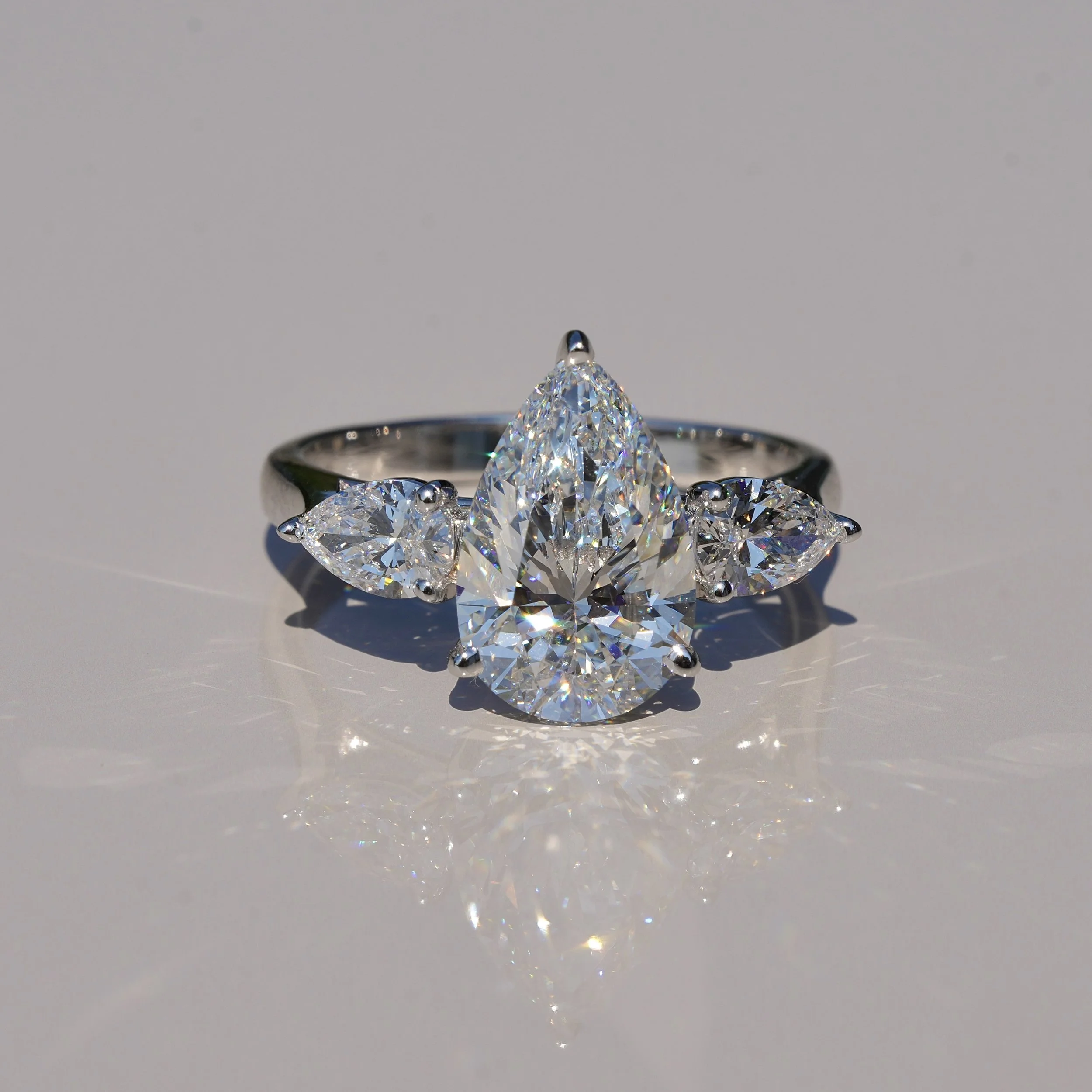 3ct Pear Cut Diamond Trilogy Engagement Ring with Two 0.4ct Side Stones in 18ct White Gold, Total 3.8ct – Front View | Eighty8Diamonds