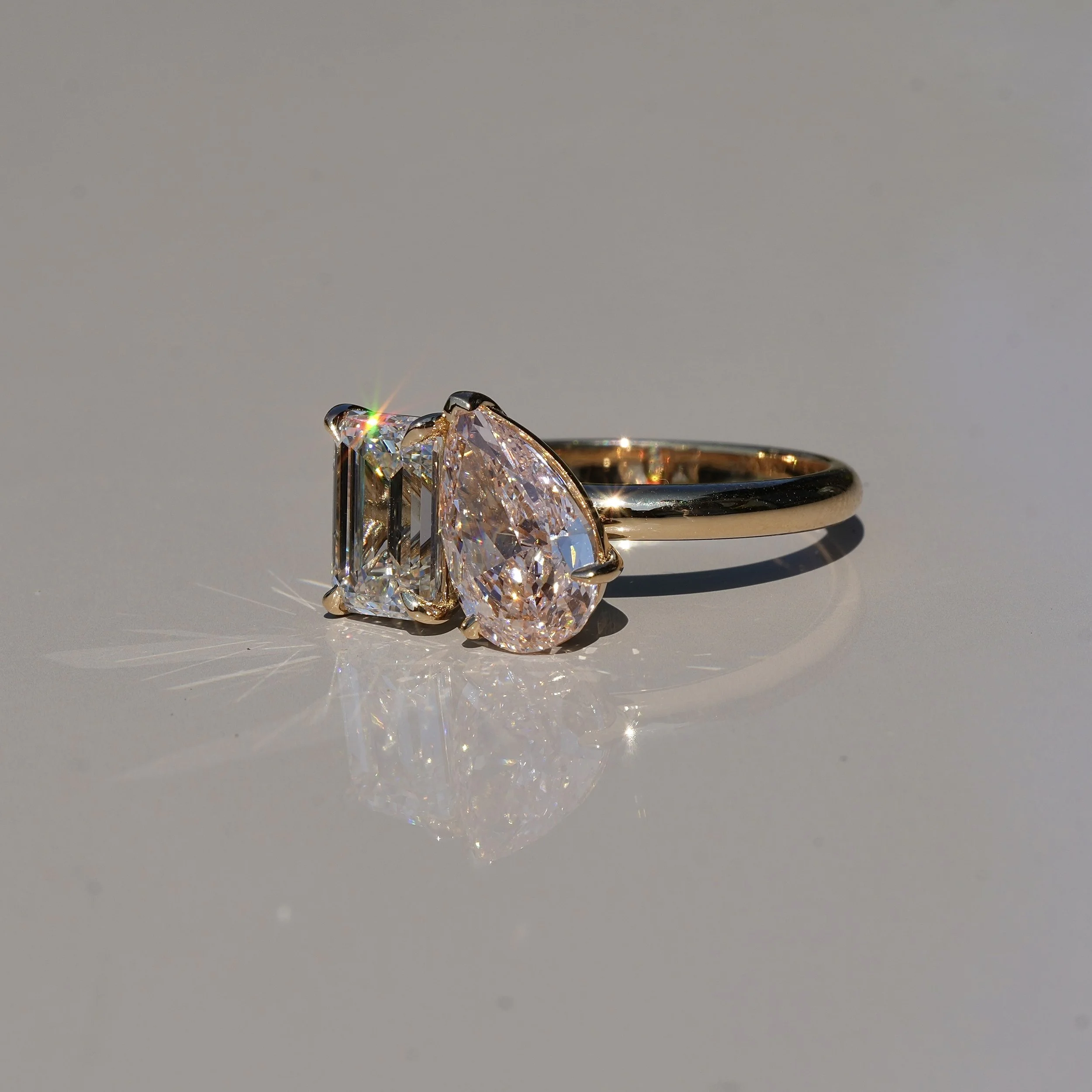 Toi et Moi Ring with 1.5ct Fancy Intense Pink Pear Cut Diamond and 1.5ct Emerald Cut Diamond in 18ct Yellow Gold, Total Carat Weight 3ct – Side View | Eighty8Diamonds