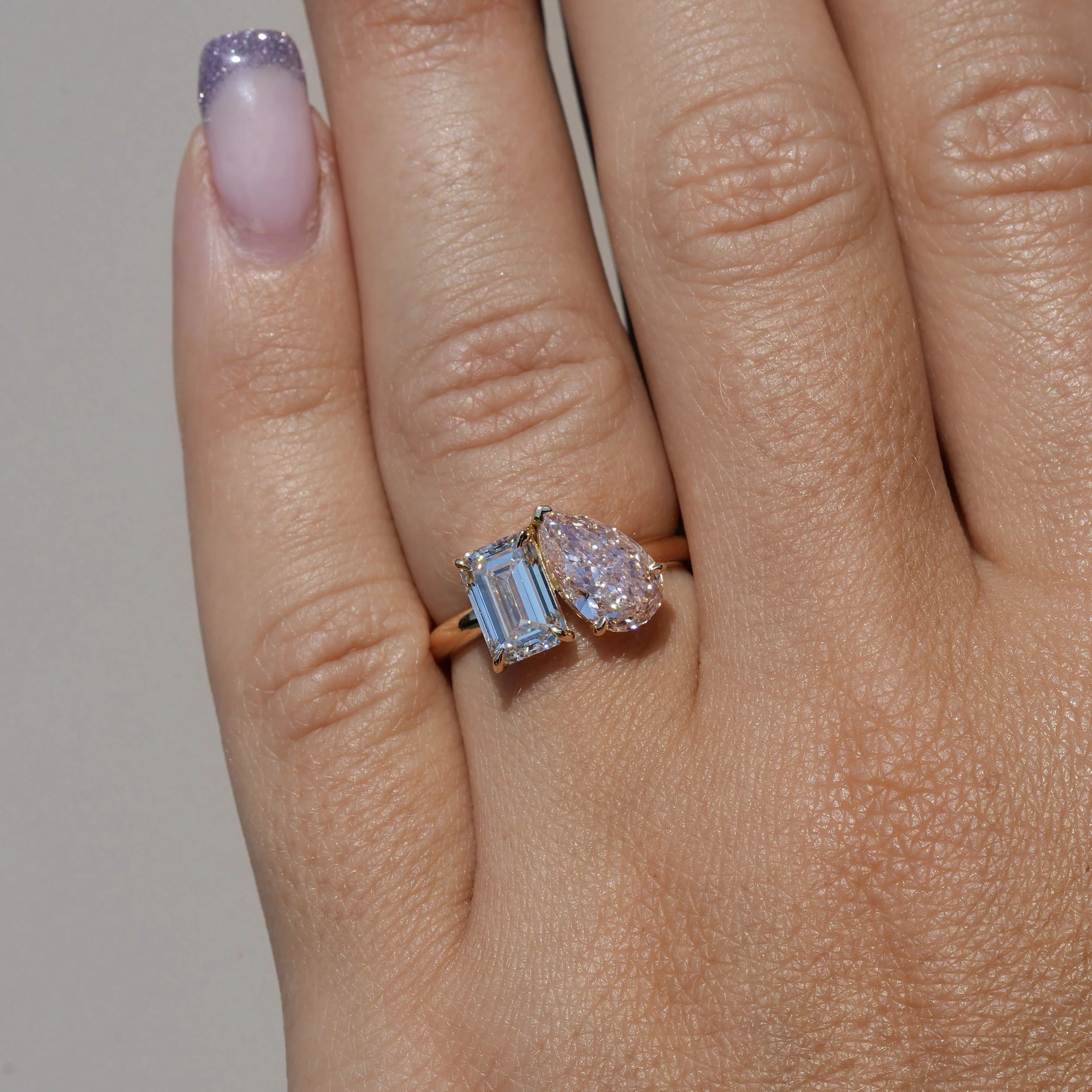 Toi et Moi Ring with 1.5ct Fancy Intense Pink Pear Cut Diamond and 1.5ct Emerald Cut Diamond in 18ct Yellow Gold, Total Carat Weight 3ct – Angeled View | Eighty8Diamonds