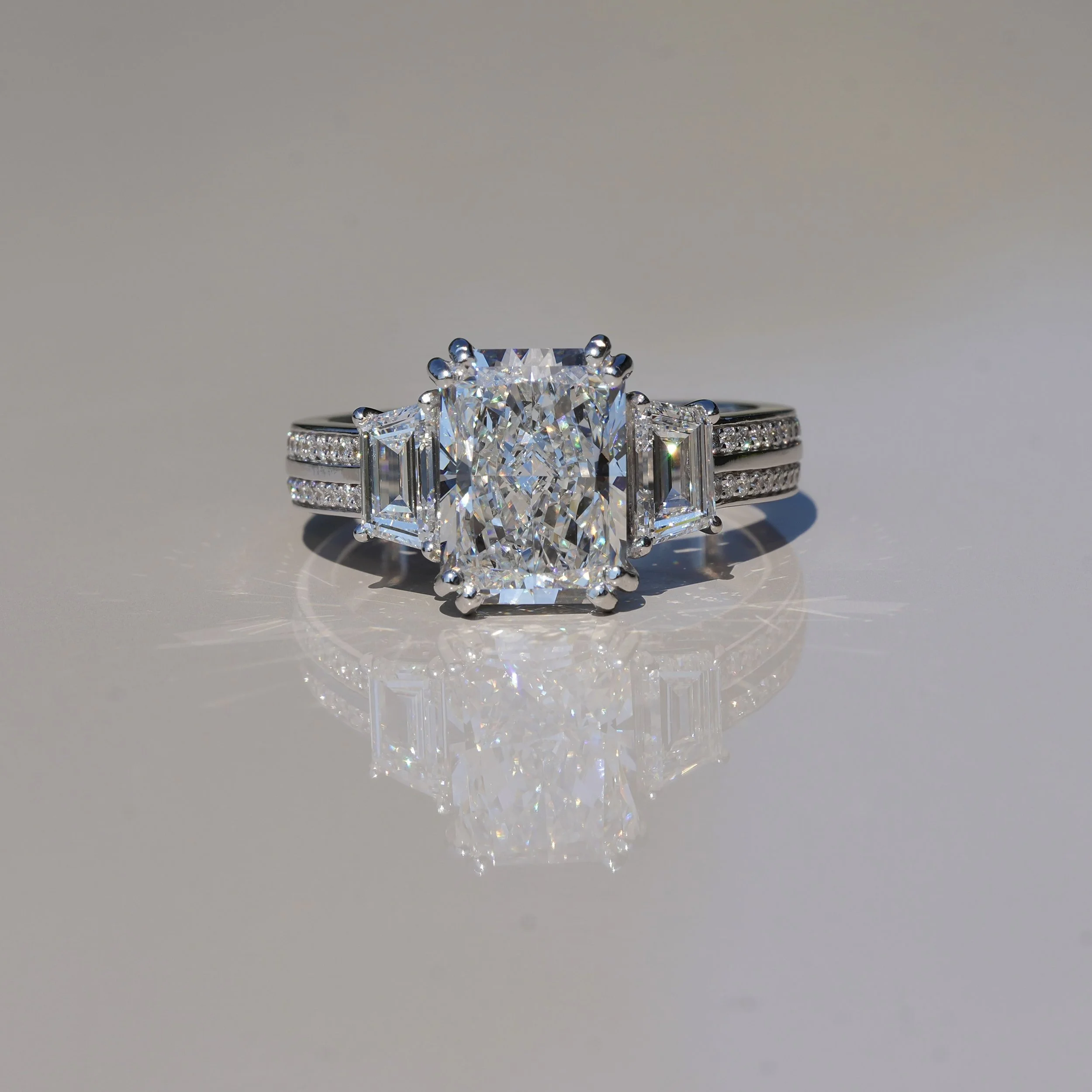 4ct Radiant Cut Diamond Engagement Ring with 3D Diamond Band and Trapezoid Side Stones in 18ct White Gold – Angled View | Eighty8Diamonds