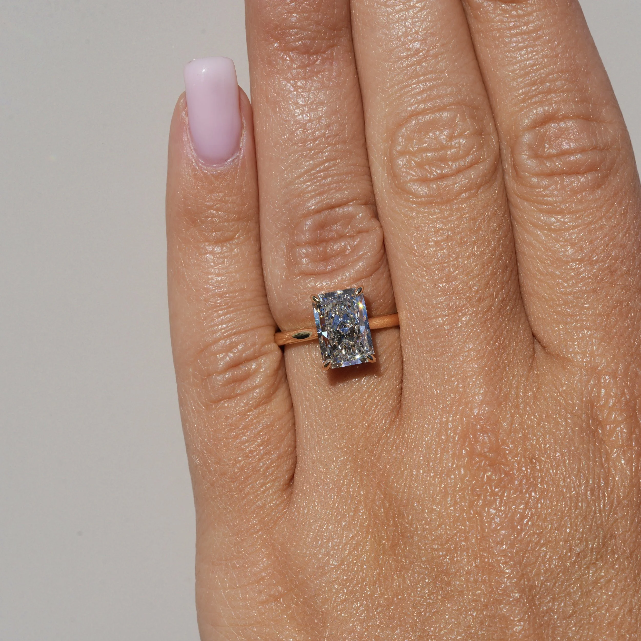 3ct Radiant Cut Diamond Solitaire Engagement Ring with Hidden Halo  in 18ct Yellow Gold – Hand View | Eighty8Diamonds