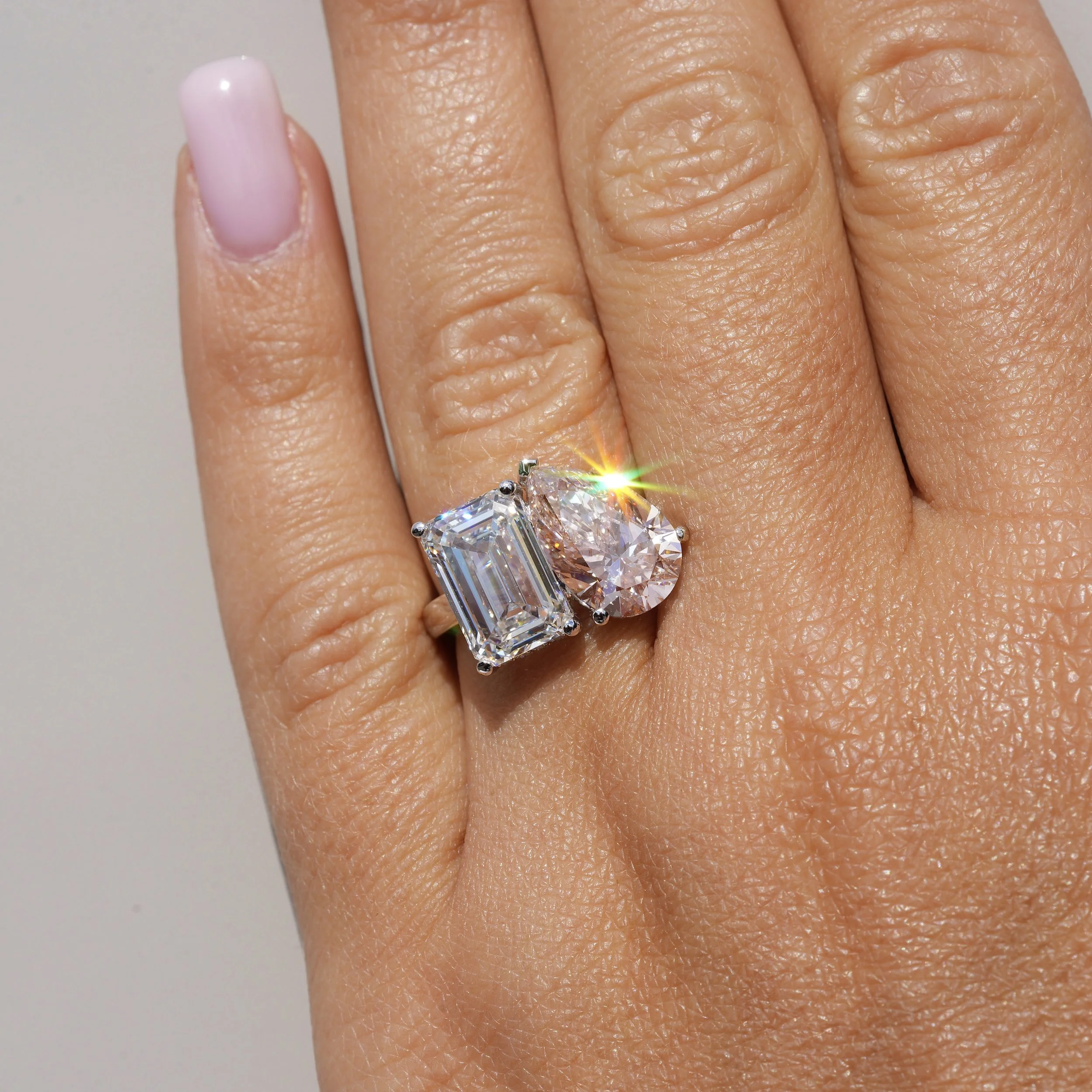 Toi et Moi Ring with 3.5ct Fancy Vivid Pink Pear Cut Diamond and 4.0ct Emerald Cut Diamond with Hidden Halo in Platinum, Total Carat Weight 7.70ct –Hand View | Eighty8Diamonds