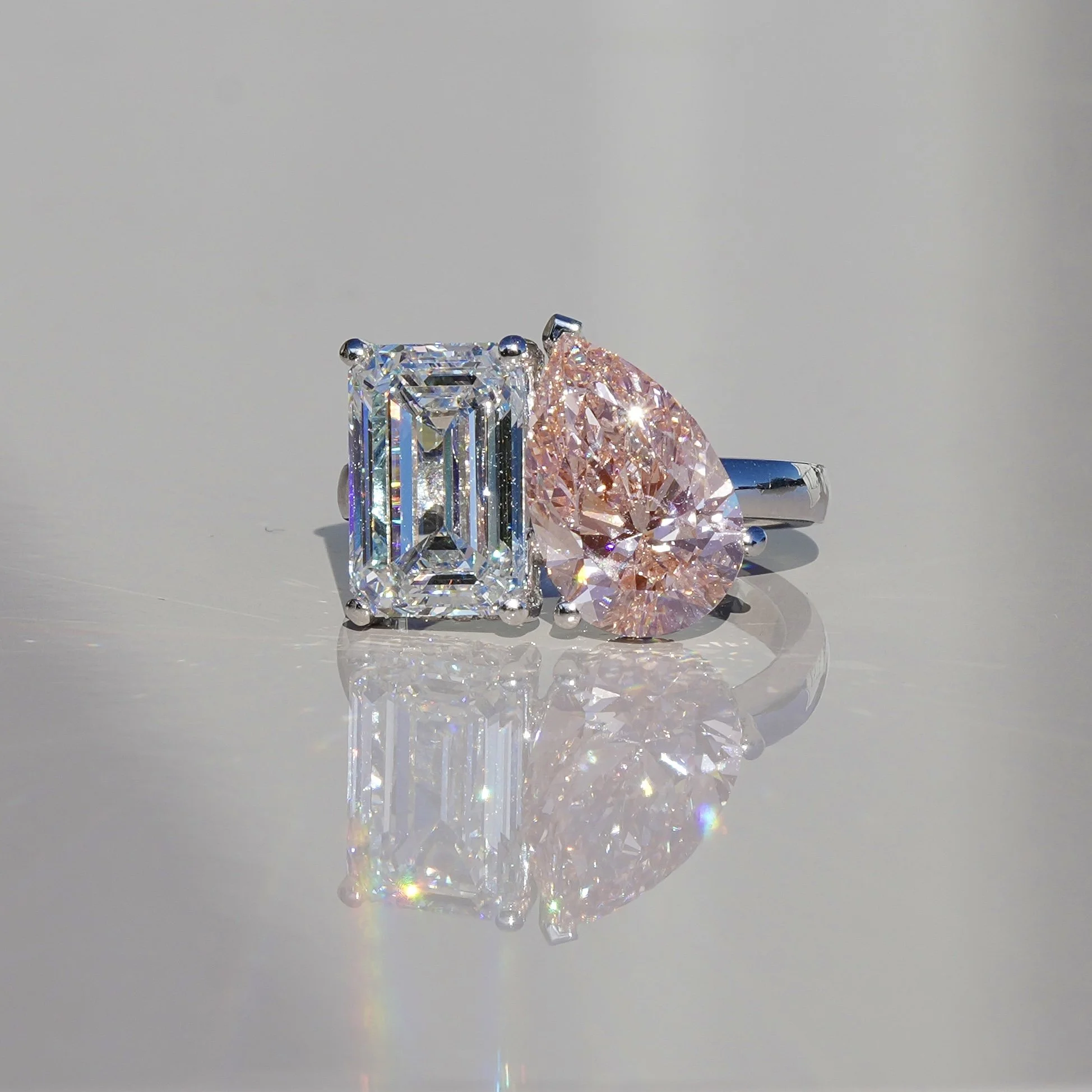 Toi et Moi Ring with 3.5ct Fancy Vivid Pink Pear Cut Diamond and 4.0ct Emerald Cut Diamond with Hidden Halo in Platinum, Total Carat Weight 7.70ct – Front View | Eighty8Diamonds