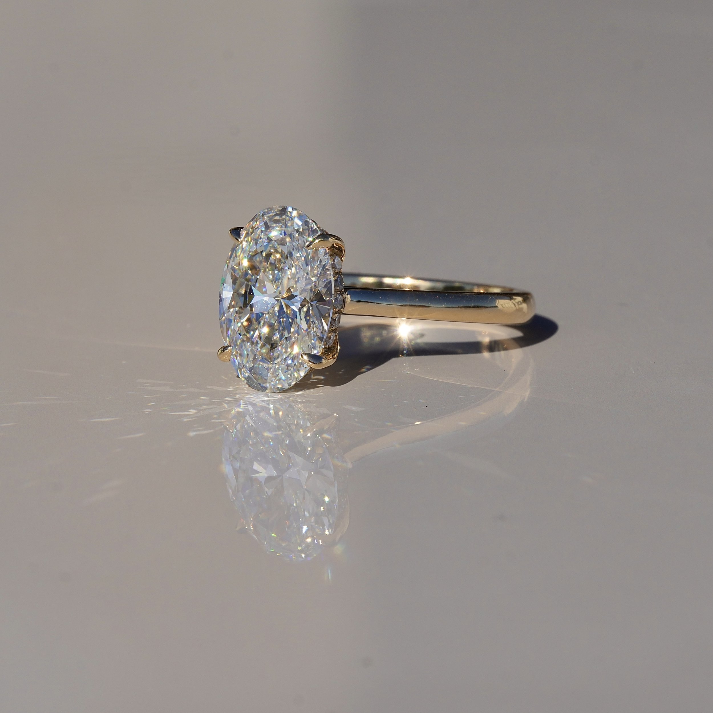 3ct Oval Cut Diamond Engagement Ring With Hidden Halo in 18ct Yellow Gold - Side View |