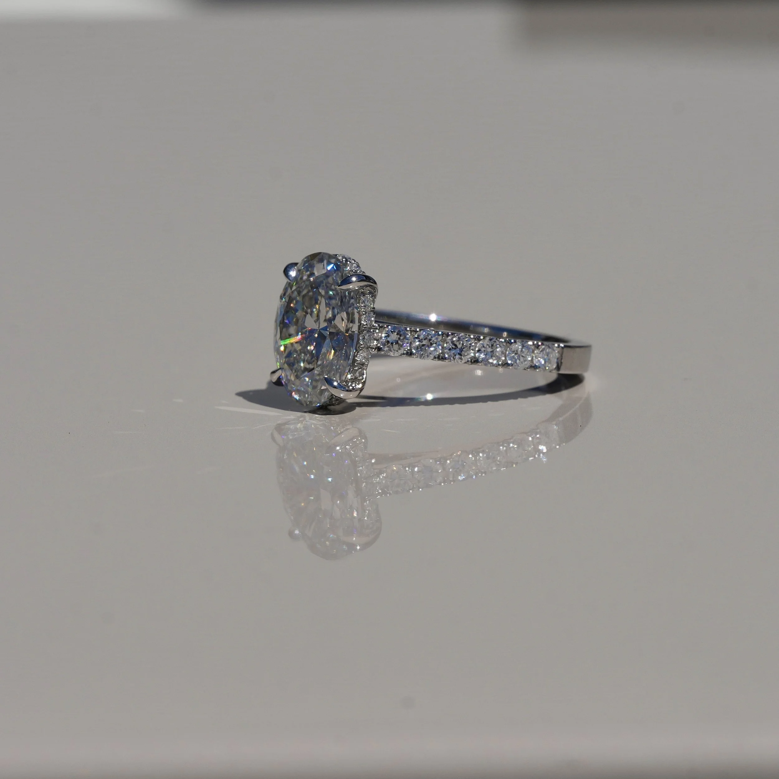 2ct Oval Cut Diamond Engagement Ring with Diamond Band in Platinum –Angeled View | Eighty8Diamonds