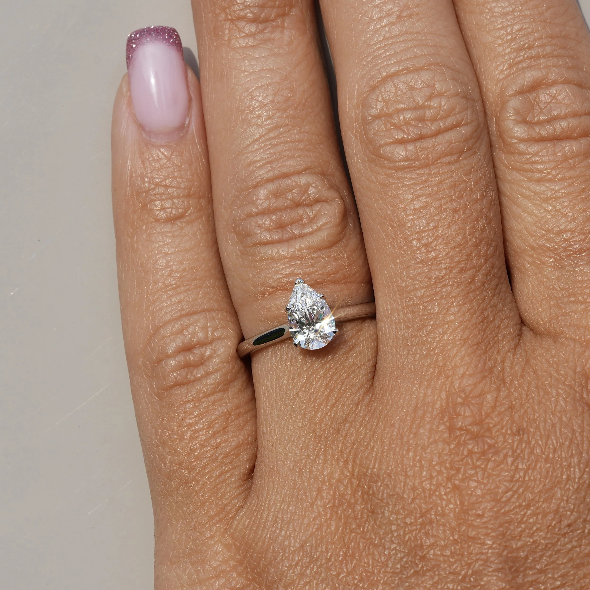 1ct Pear Cut Diamond Hidden Halo Ring in Platinum – IGI Certified – Hand View | Eighty8Diamonds