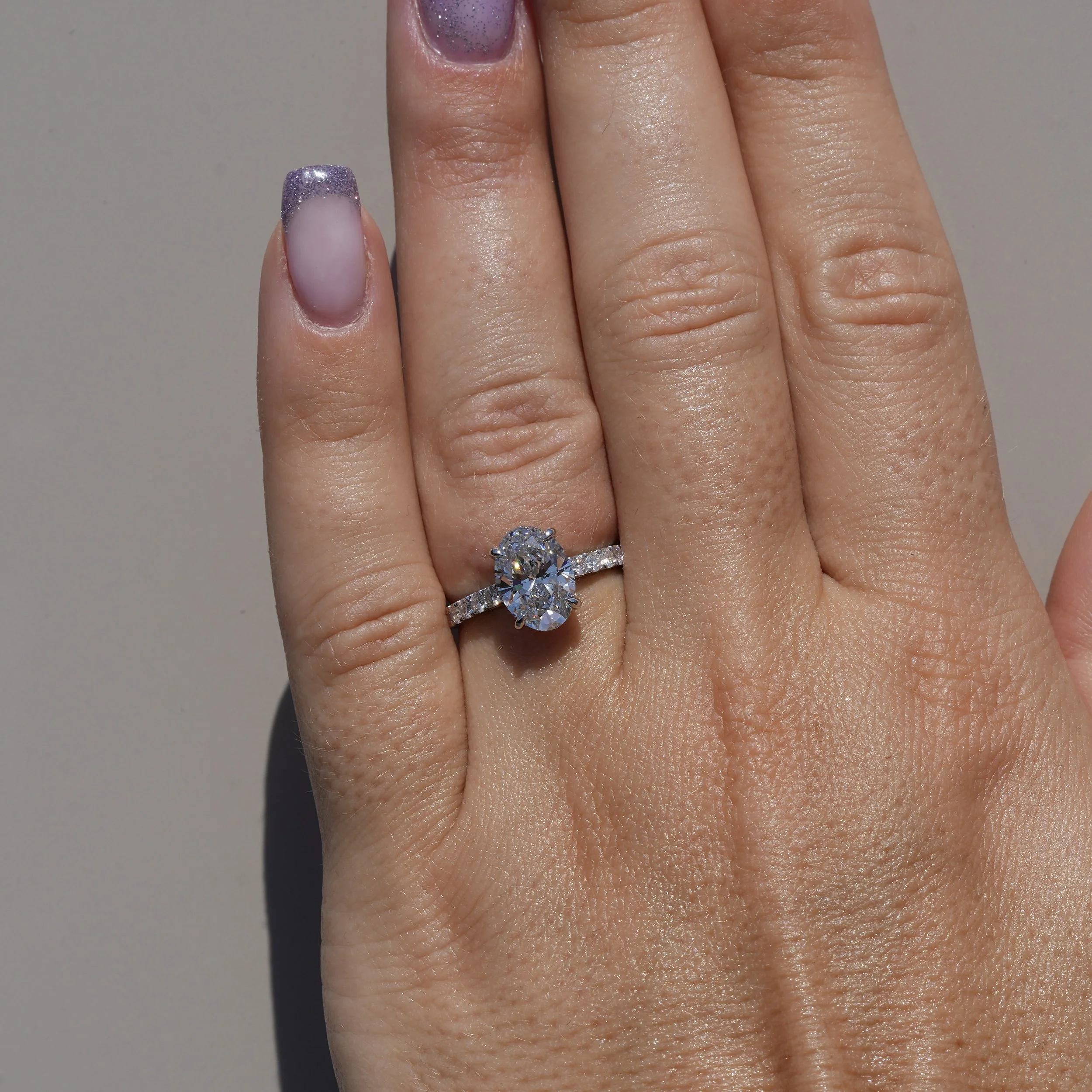 2ct Oval Cut Diamond Engagement Ring with Diamond Band in Platinum –Hand View | Eighty8Diamonds
