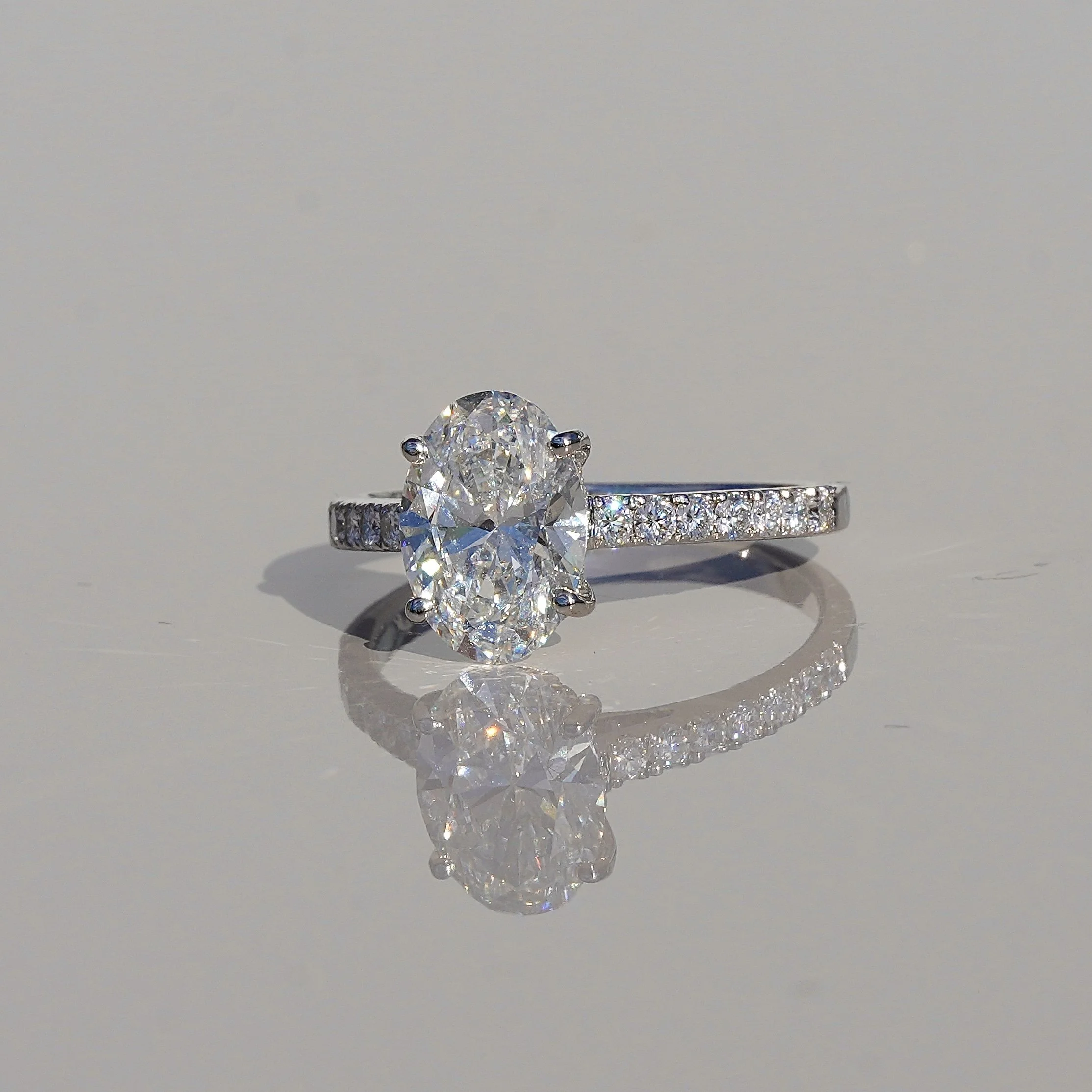 2ct Oval Cut Diamond Engagement Ring with Diamond Band in 18ct White Gold – Angeled View | Eighty8Diamonds