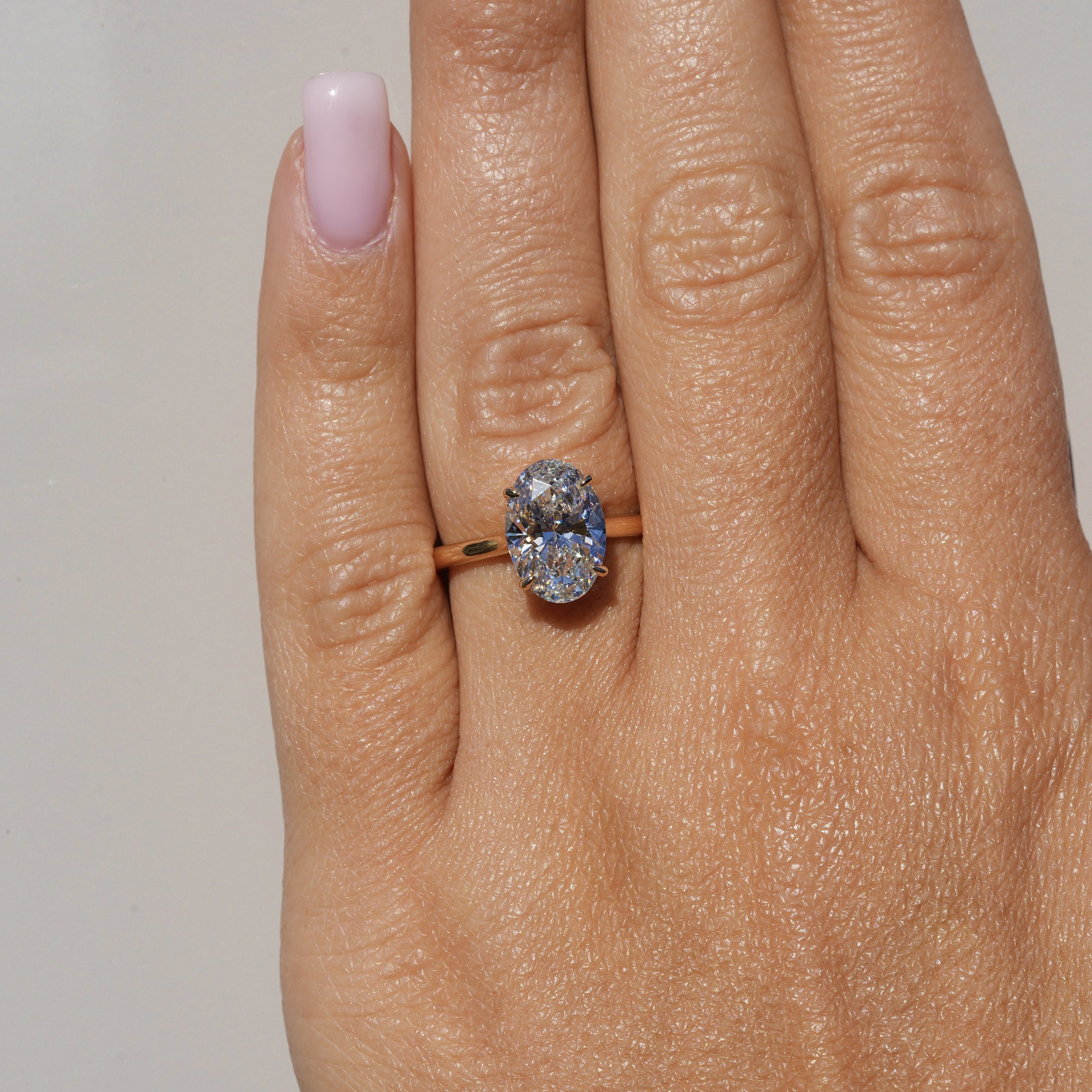 3ct Oval Cut Diamond Engagement Ring With Hidden Halo in 18ct Yellow Gold - Hand View |