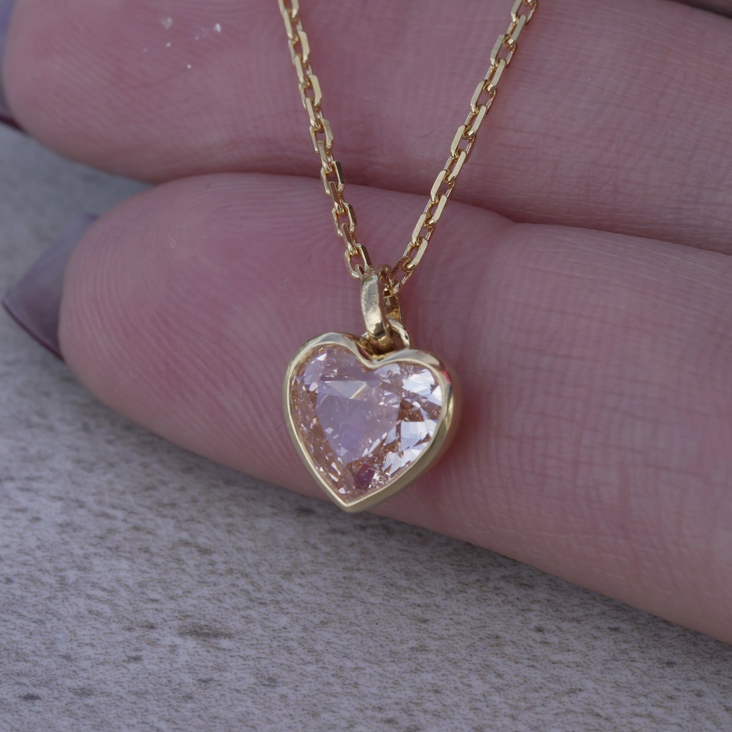 2ct Fancy Vivid Pink Heart Diamond Pendant in 18K Yellow Gold, IGI Certified – Hand View | Eighty8Diamonds
