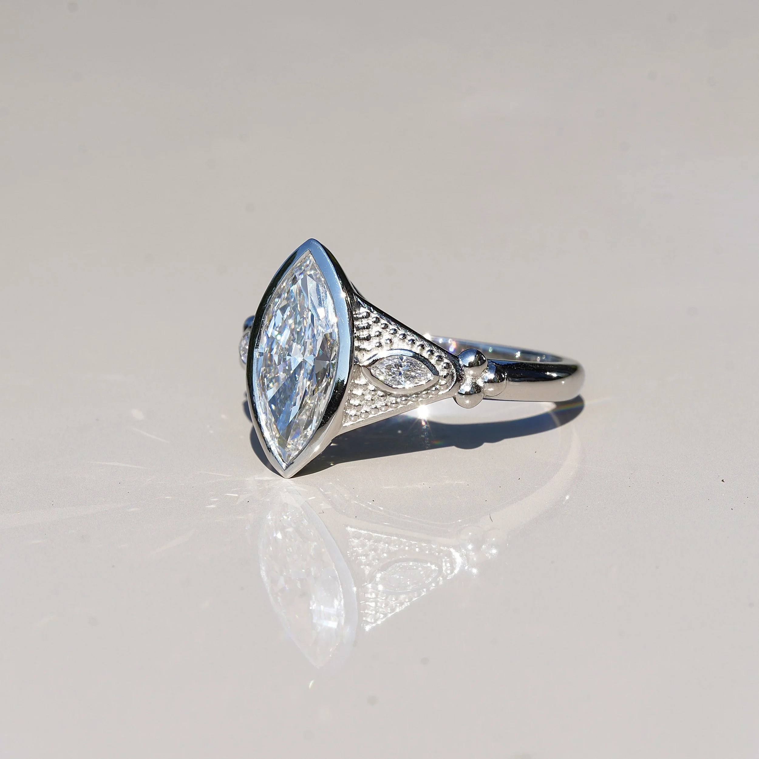 2ct Marquise Bezel Set Diamond Ring with Milgrain with two 0.1ct Side Stones in Platinum, Total 2.2ct –Side View | Eighty8Diamonds
