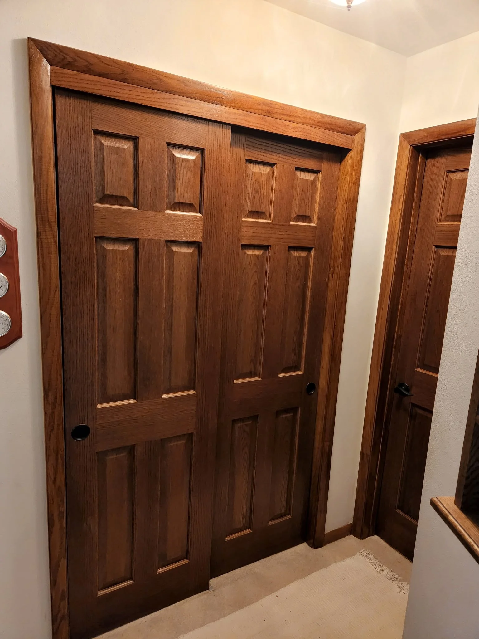 Wooden sliding closet doors in a home interior.