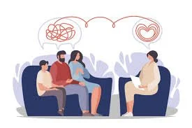 A therapy session with a therapist and three clients, two sitting on a couch and one on a chair, with thought bubbles showing a tangled line and a heart.