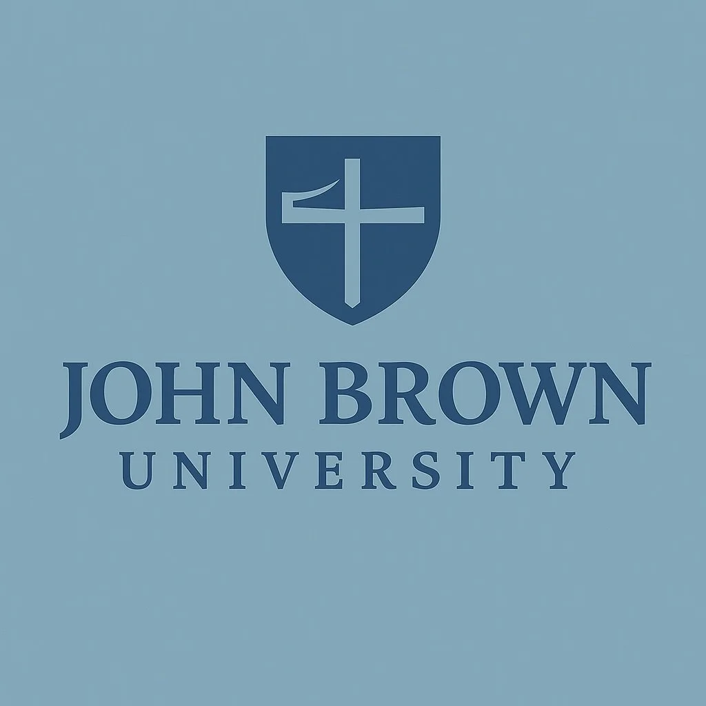 Logo of John Brown University featuring a shield with a cross and a flag, above the university's name.