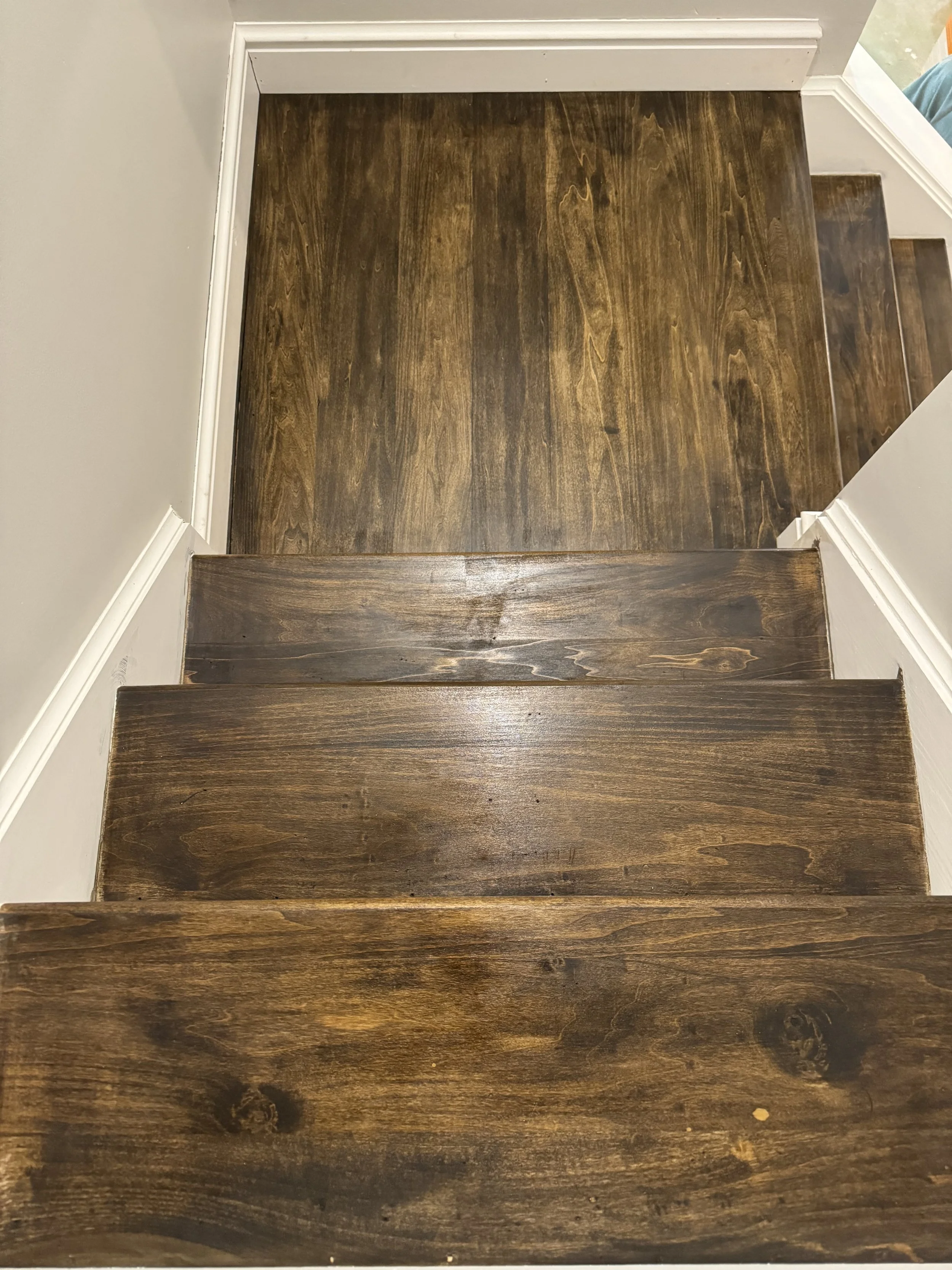 custom steps to match house flooring to basement remodel