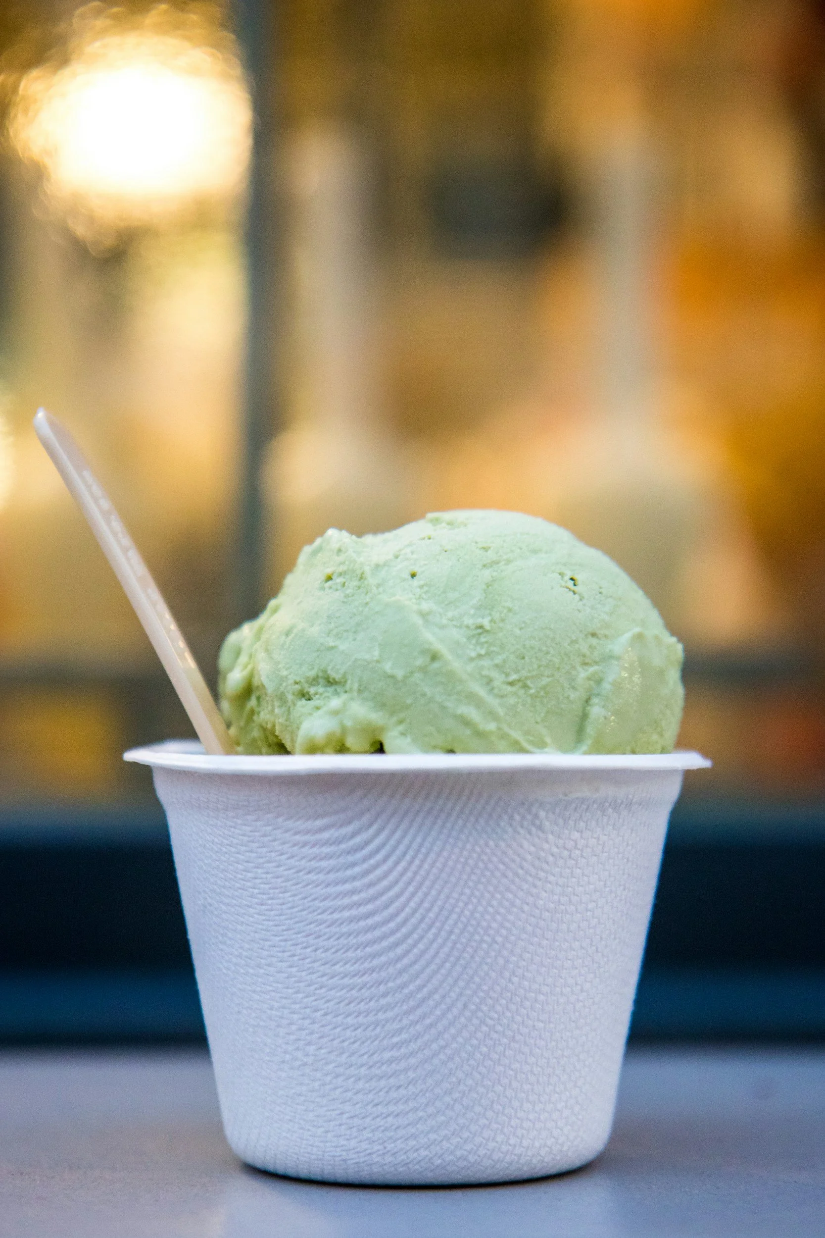Hand holding a cup of fresh ice cream at a local shop