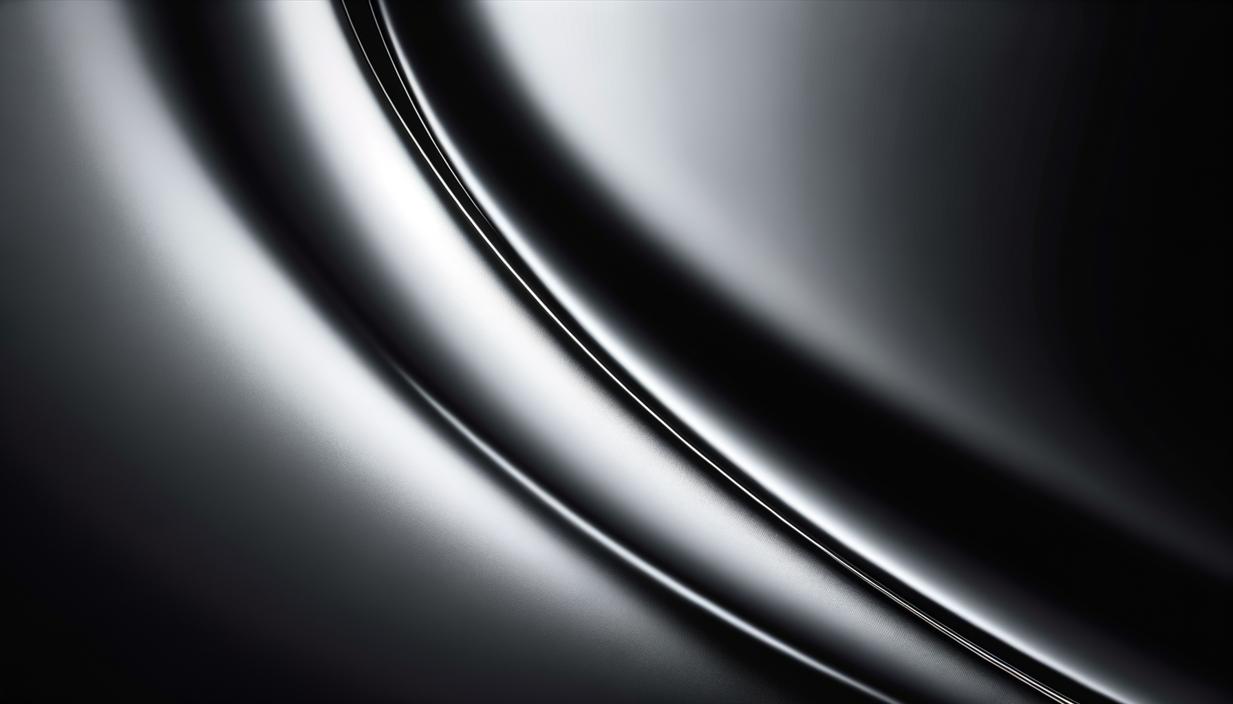 Close-up of a sleek, shiny, black metallic surface with curved lines and reflective highlights.