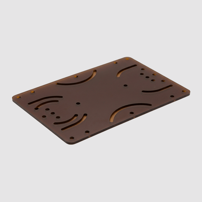 Brown plastic or metal chassis with cutouts and holes, likely for electronic components or assembling a device.