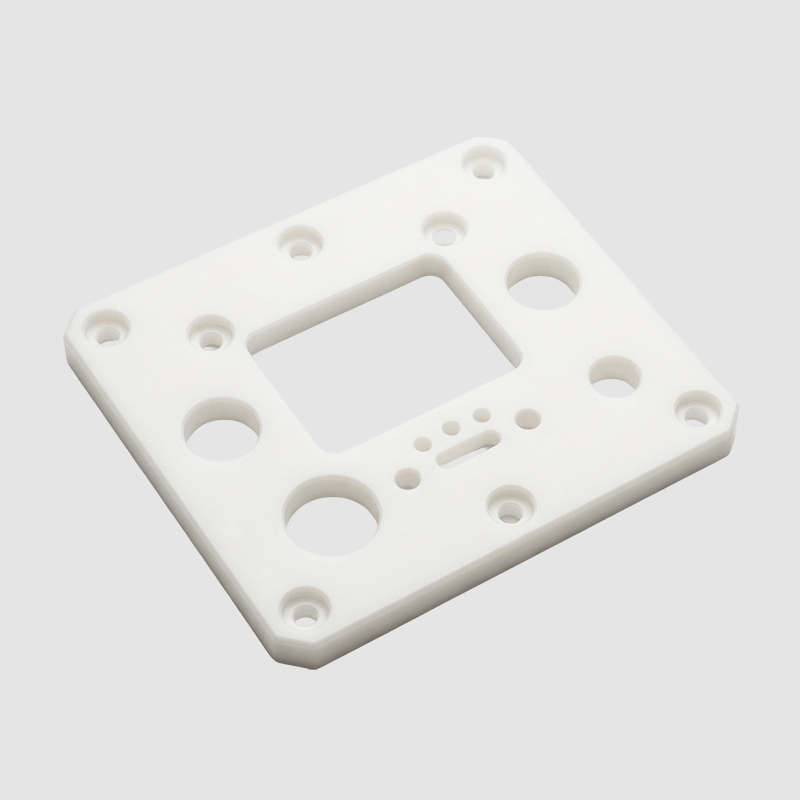 White plastic mounting plate with multiple holes and a rectangular cutout.